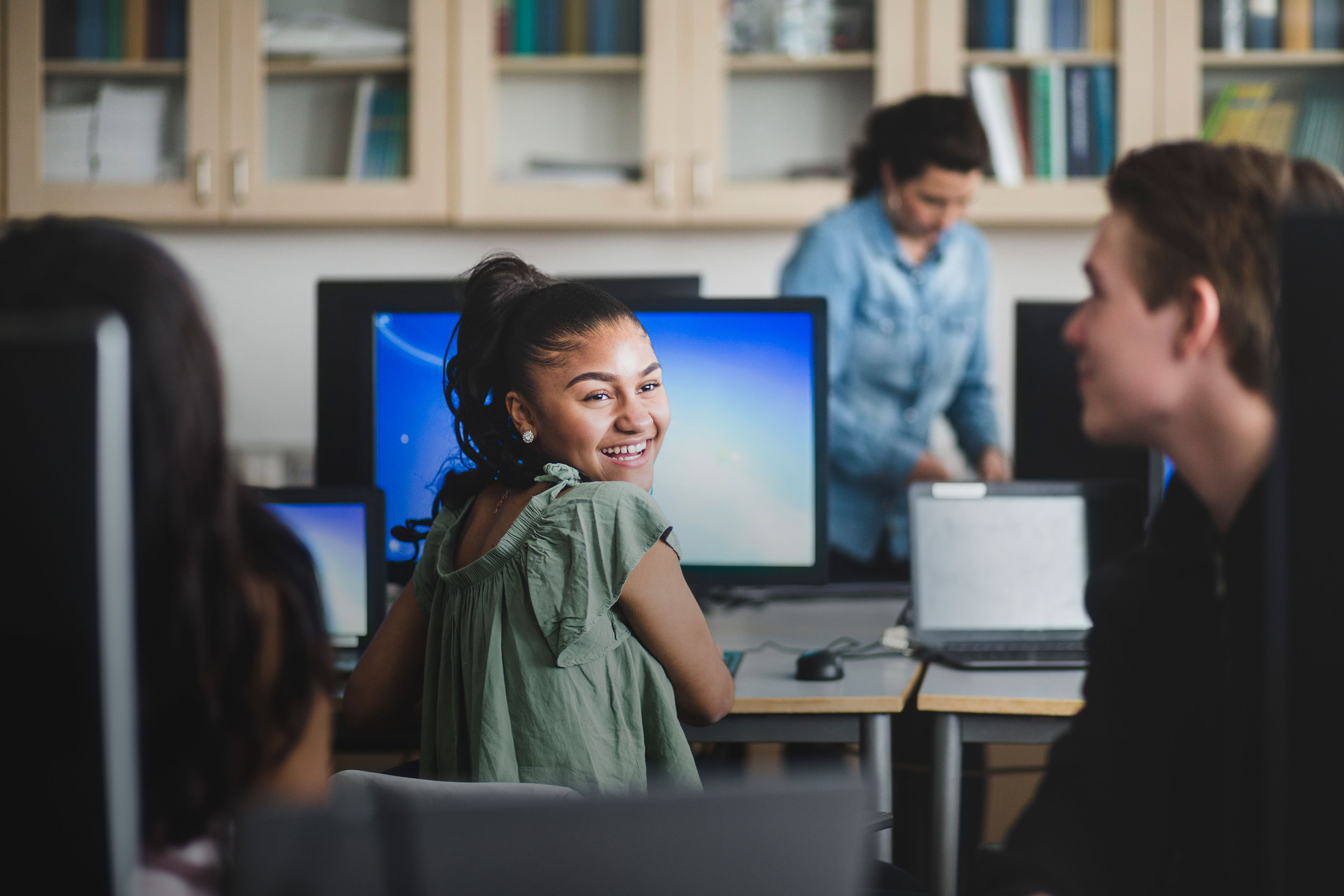 Smiling young woman using computer