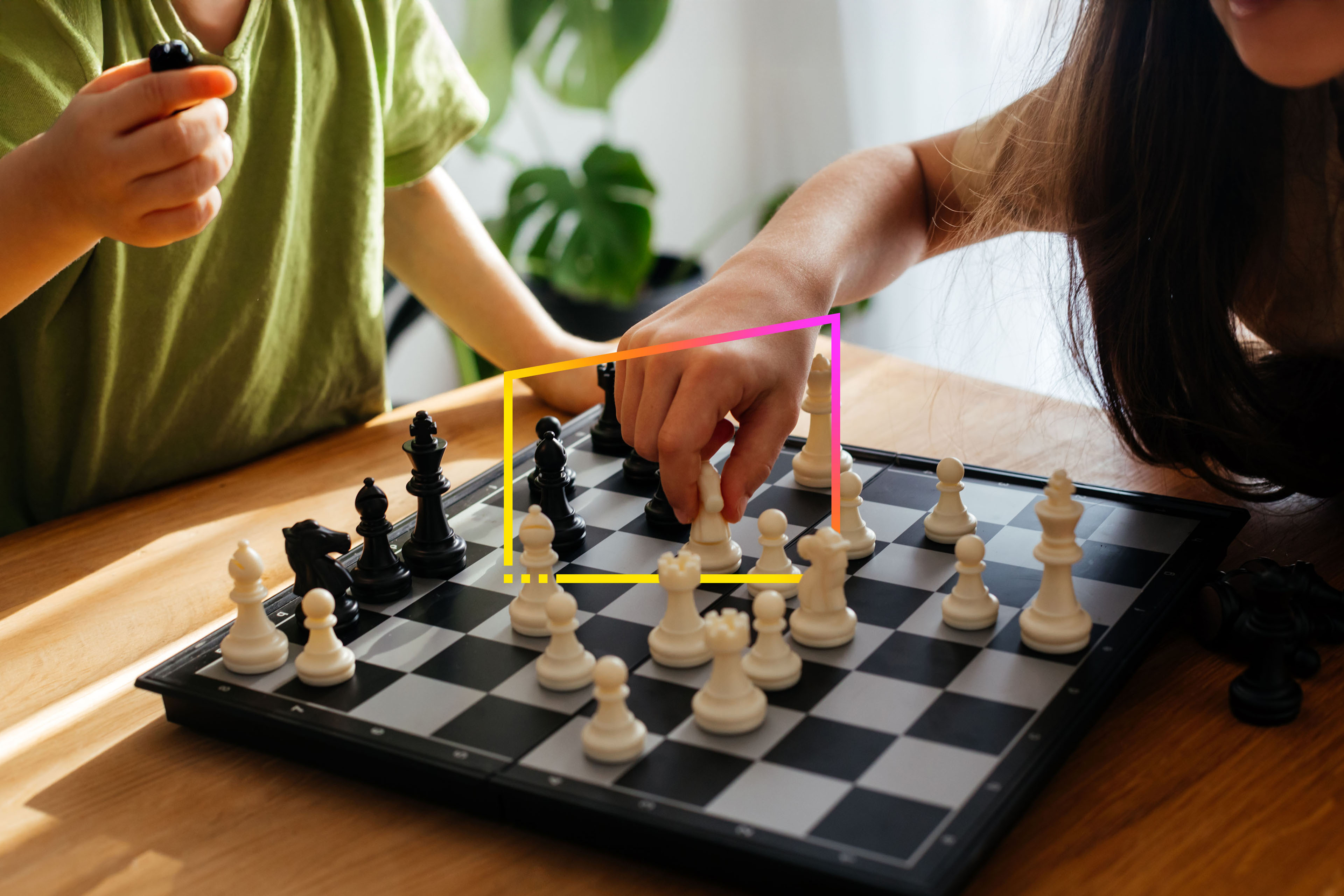 close up shot of two children playing chess together 