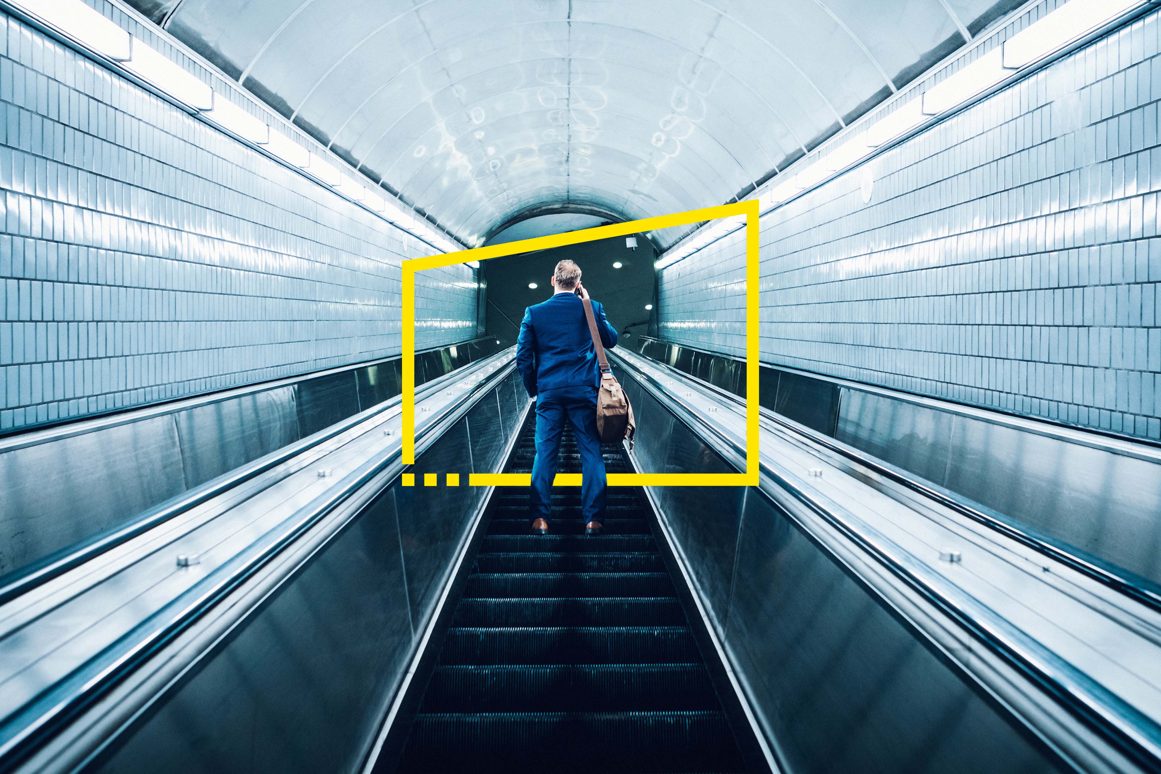 A business man on an escalator