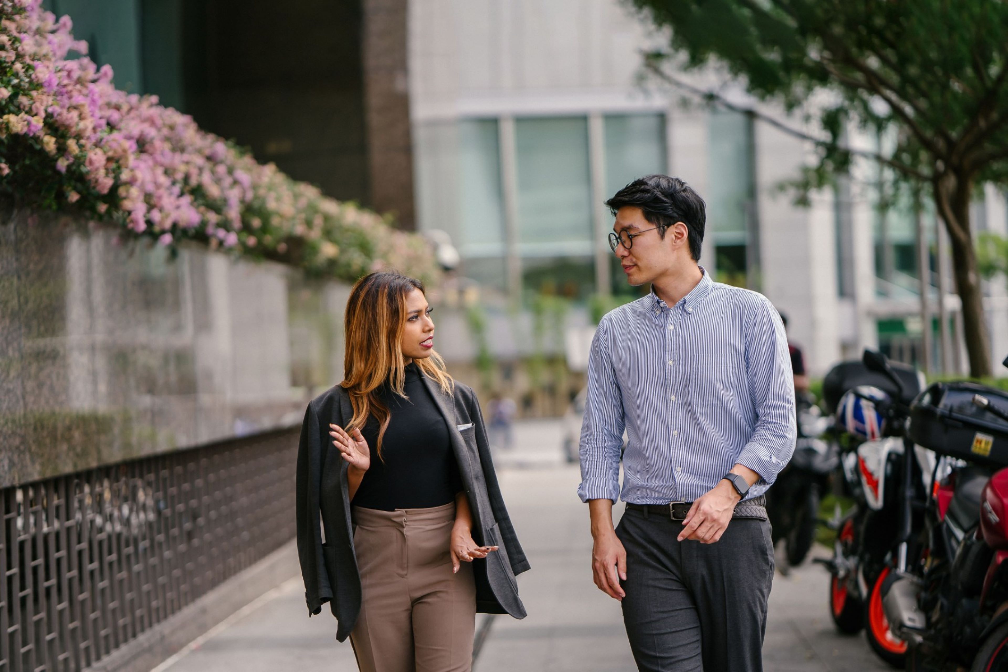 Man and woman having conversation while walking