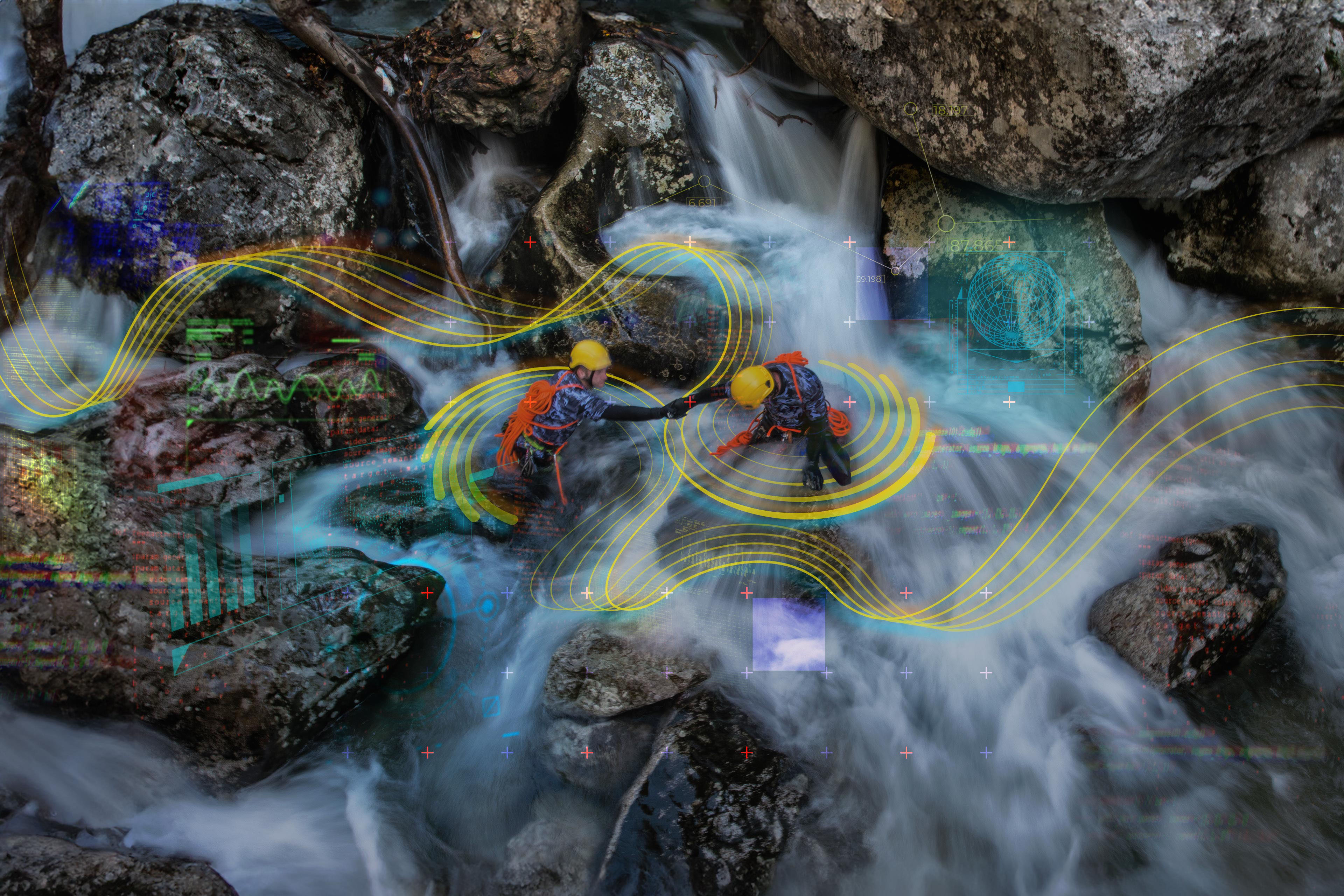  Canyoning team help each other to cross a waterfall