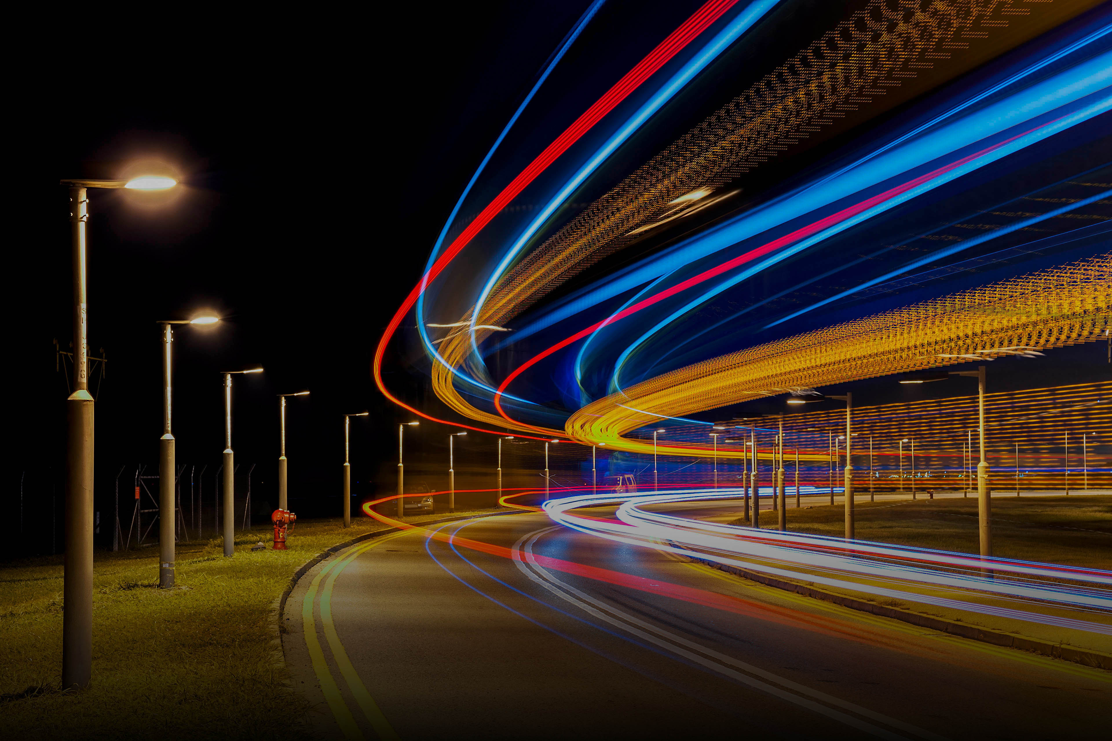 Light trails of traffic on road at night hero