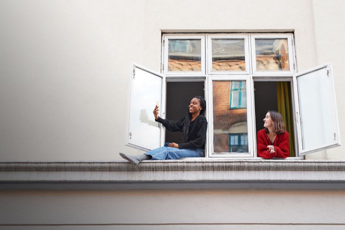 Woman taking selfie in window