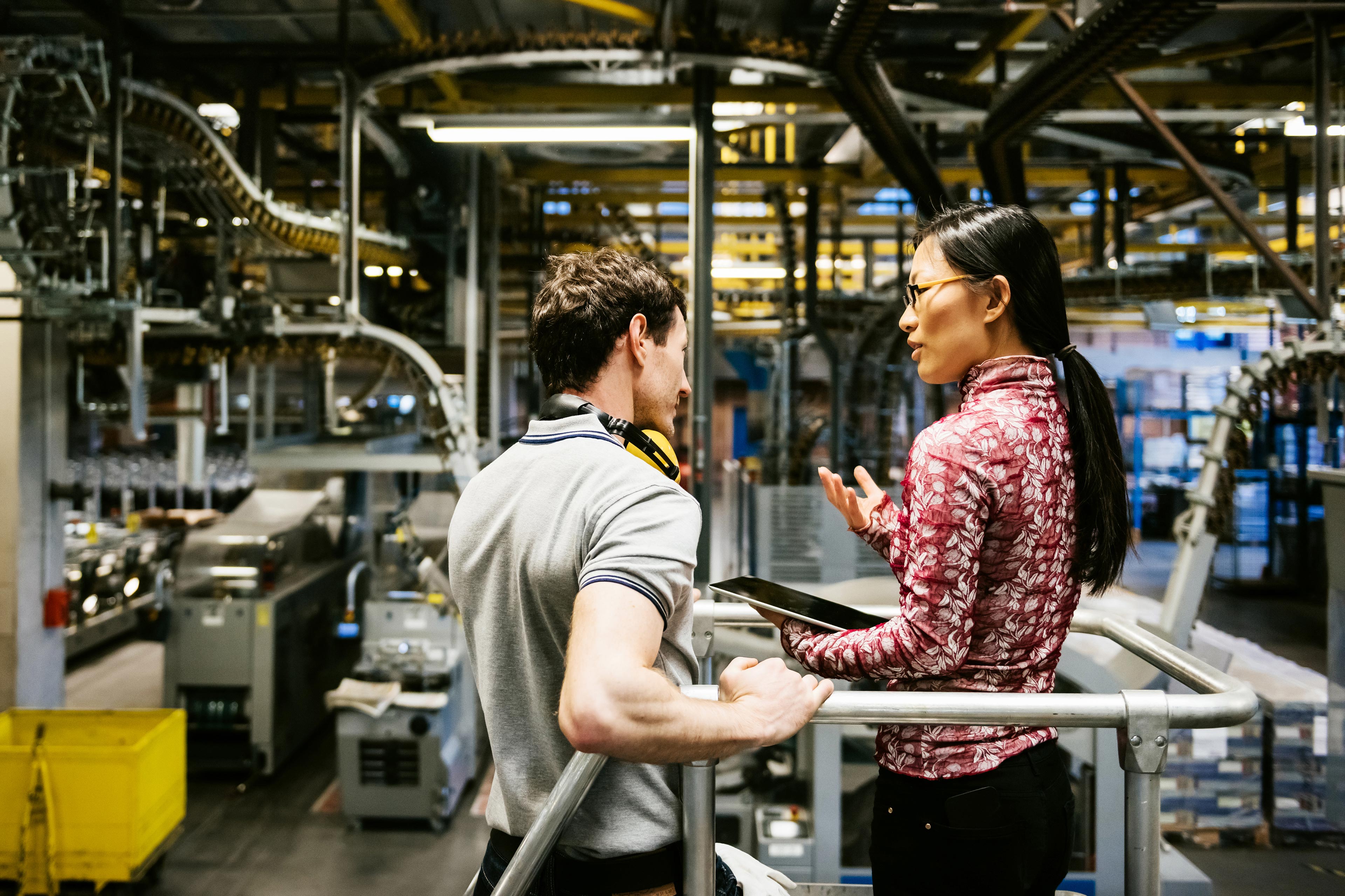 Man and women discussing about machines