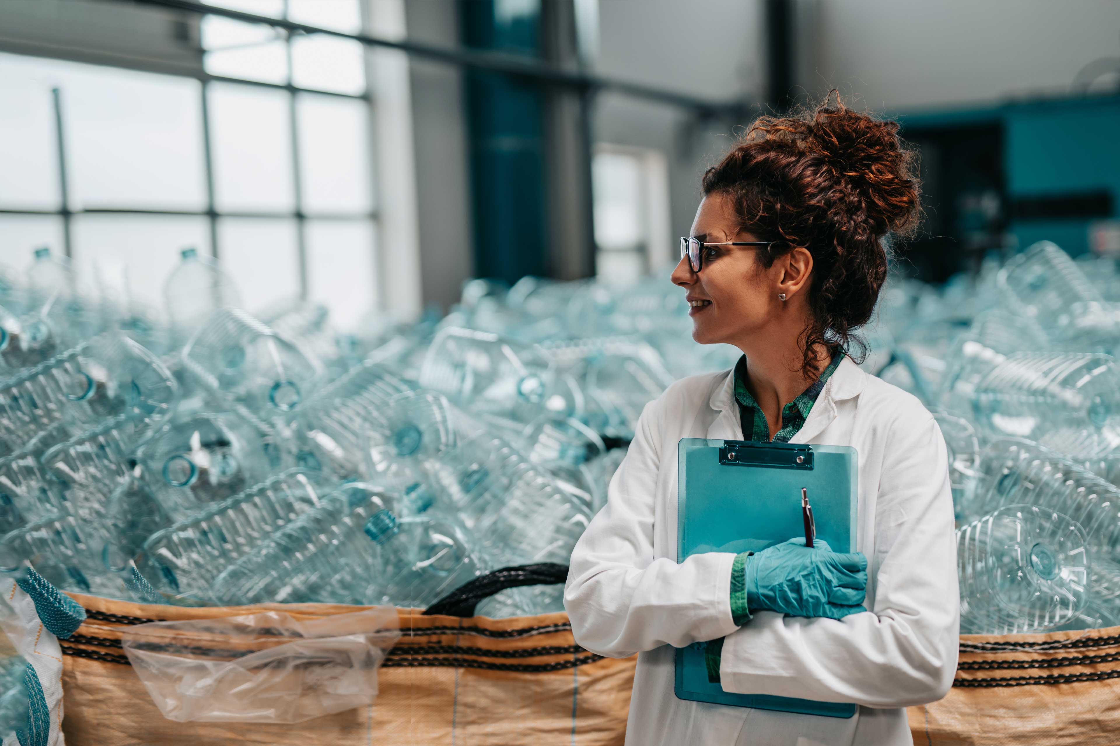 Young worker in bottling factory recycling department