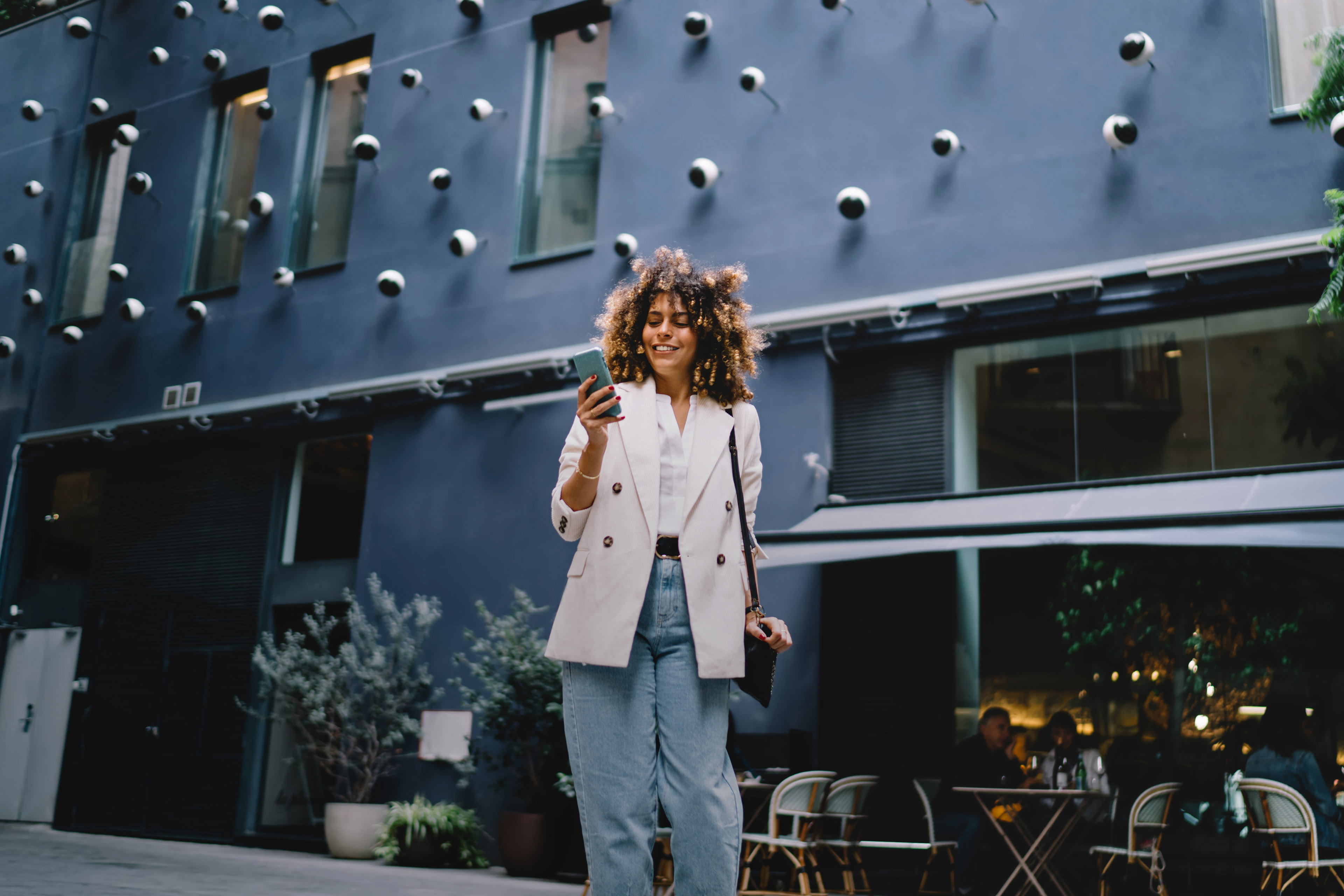 Young lady standing in the street with a smartphone