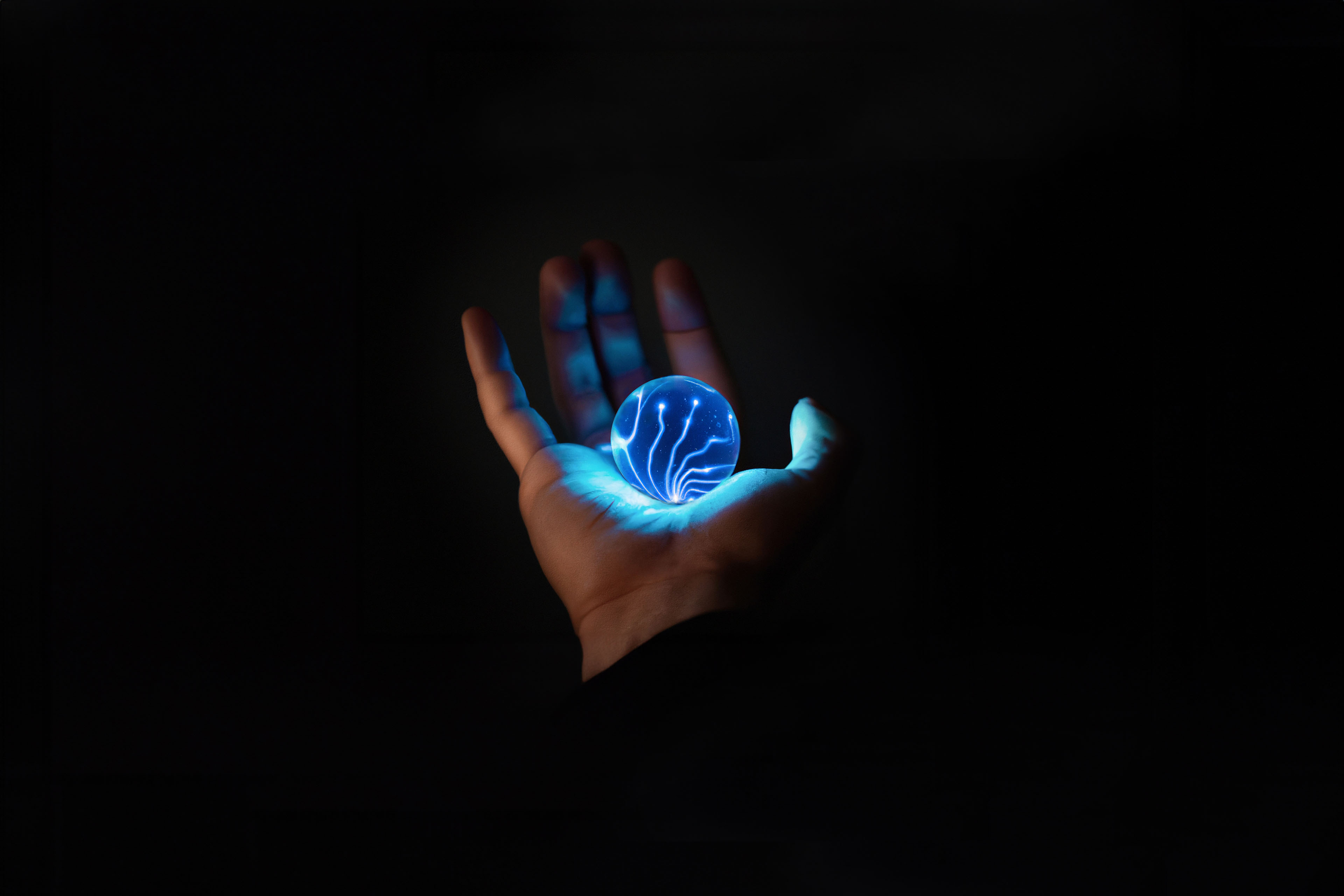 A glowing orb held in palm of the hand