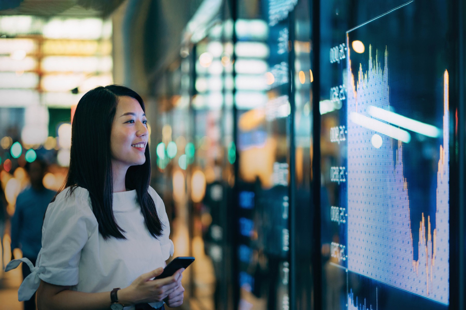 asian businesswoman checking financial trading data