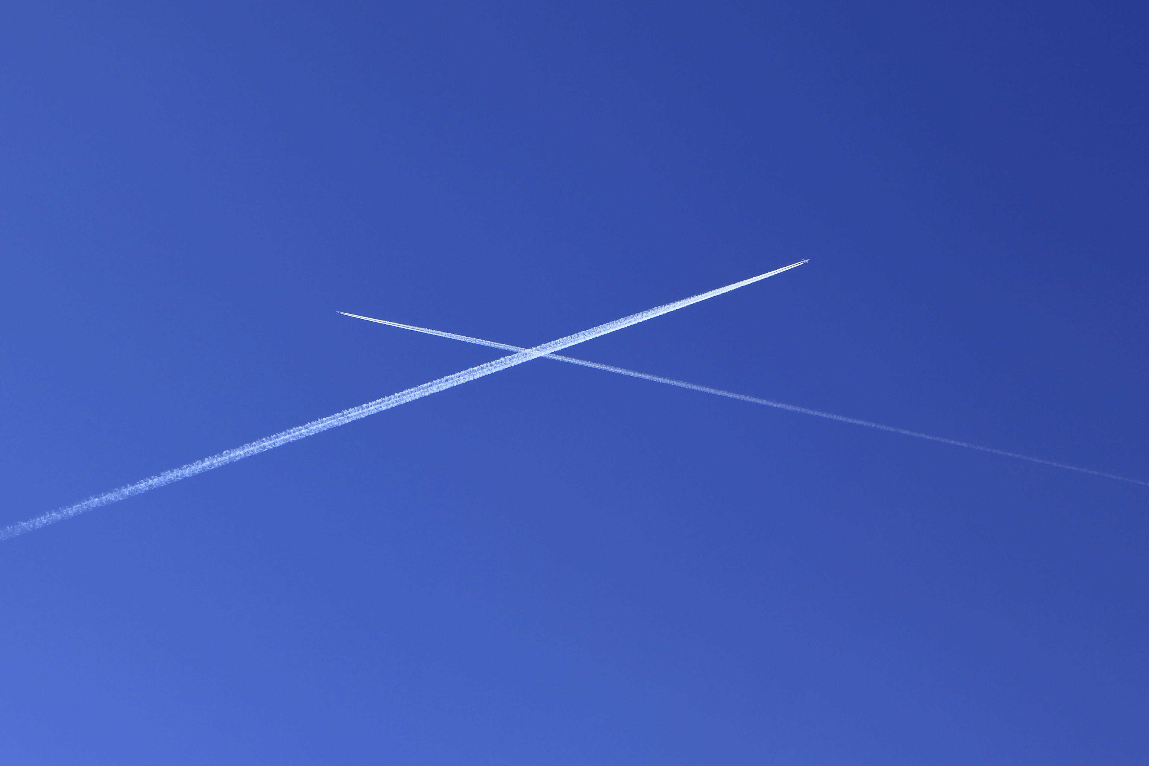 Planes crossing in blue sky