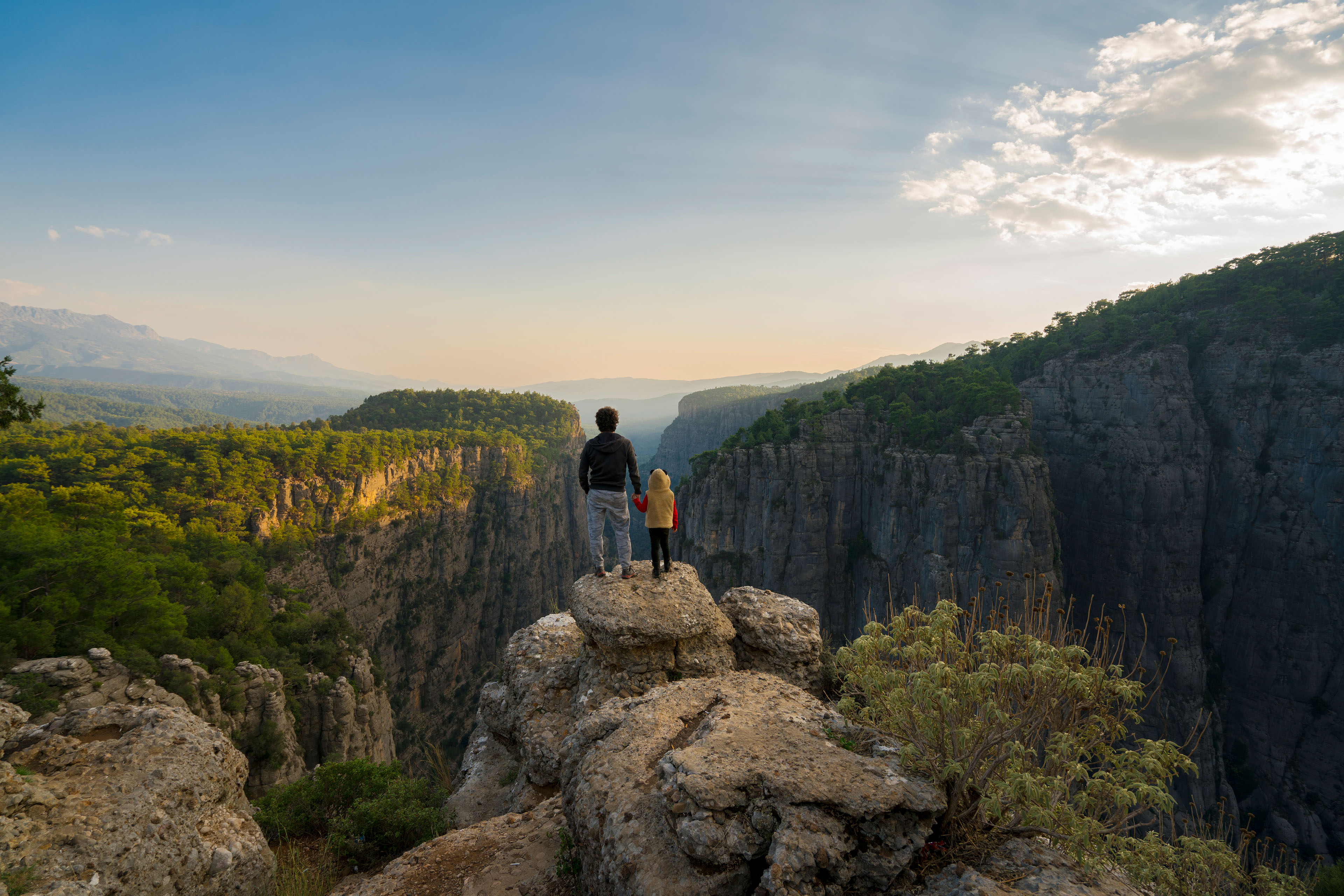 Father and daughter enjoying on the high cliffs