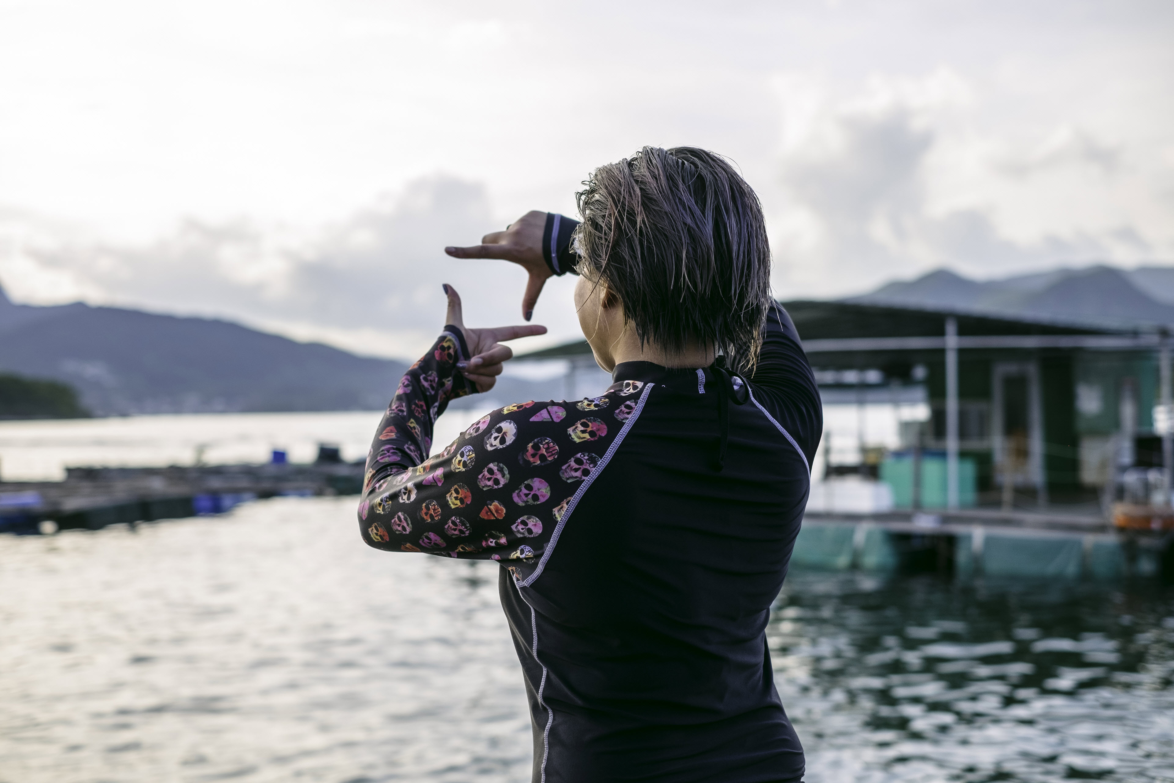 Women in swimming costume framing the water and mountains