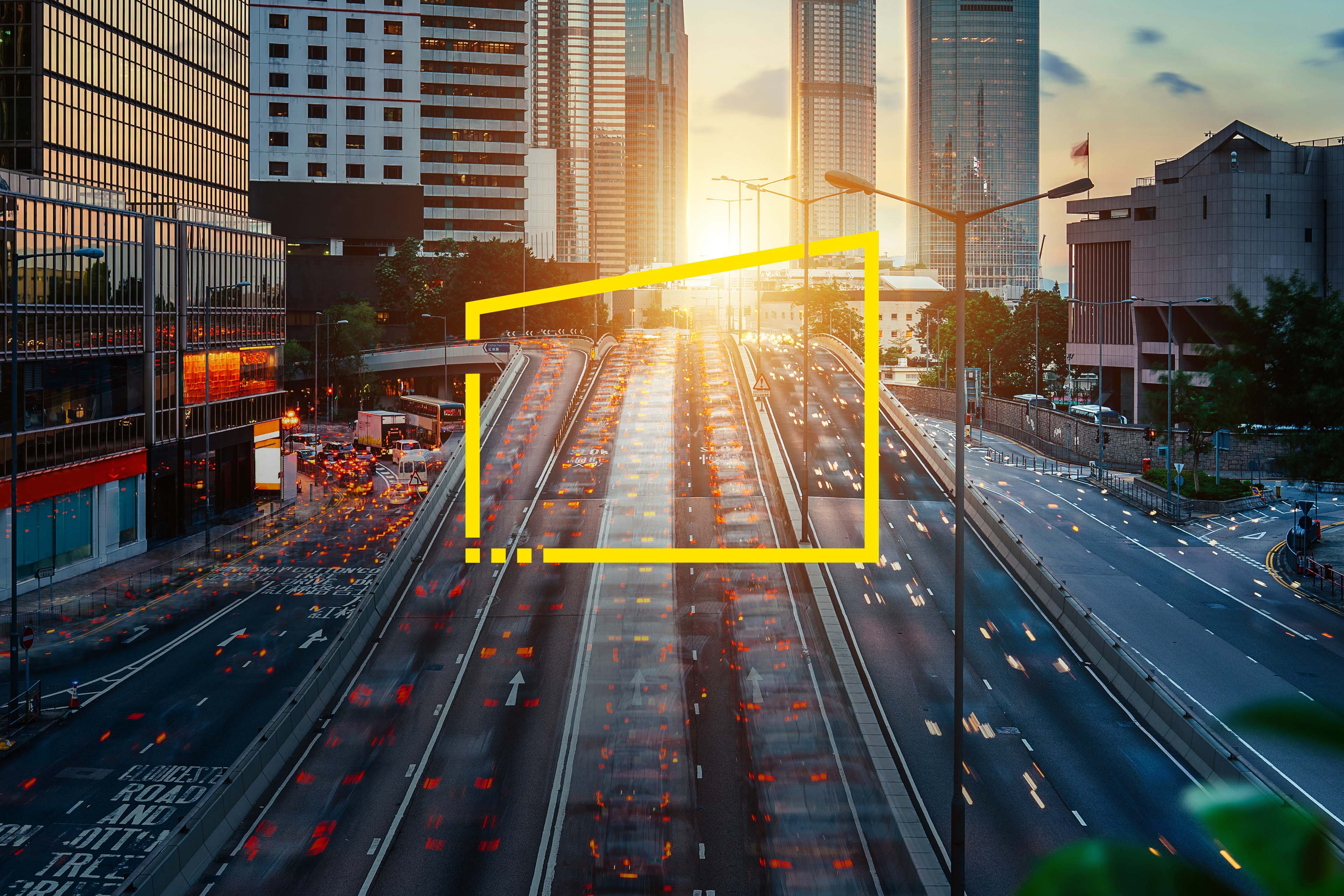 Car light trails of rush hour traffic on busy highway at sunset