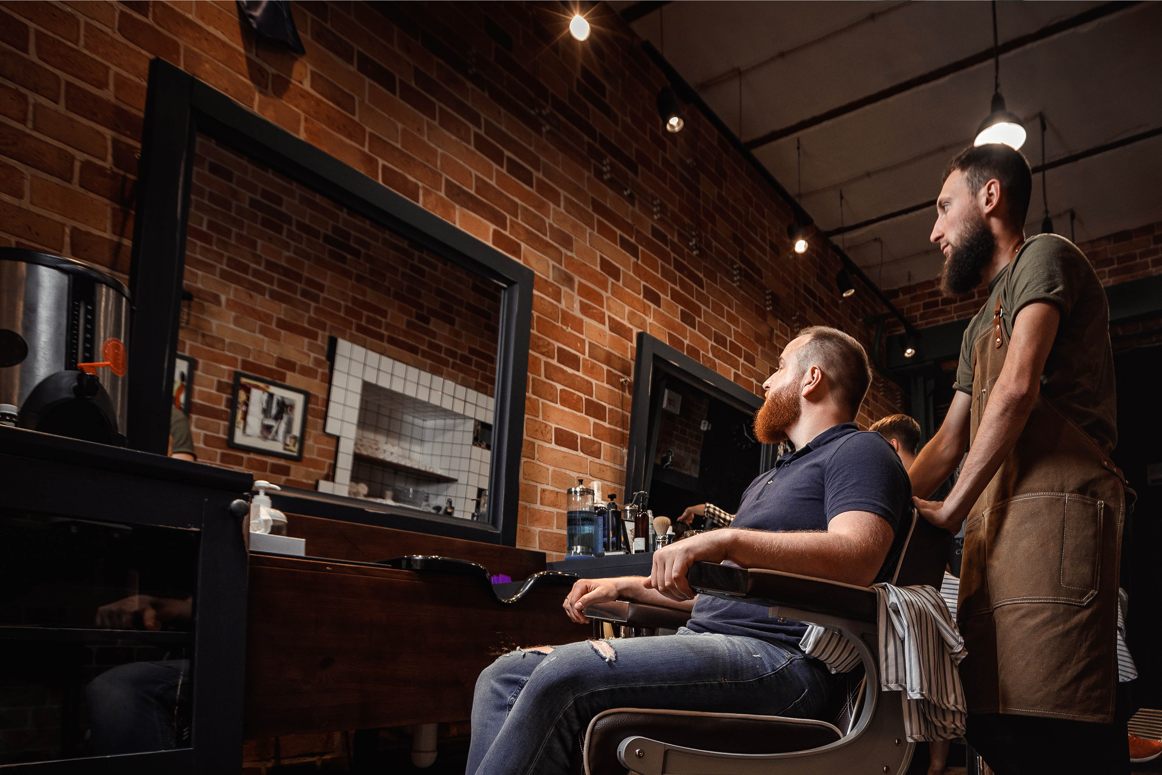 Side view of barber with male customer