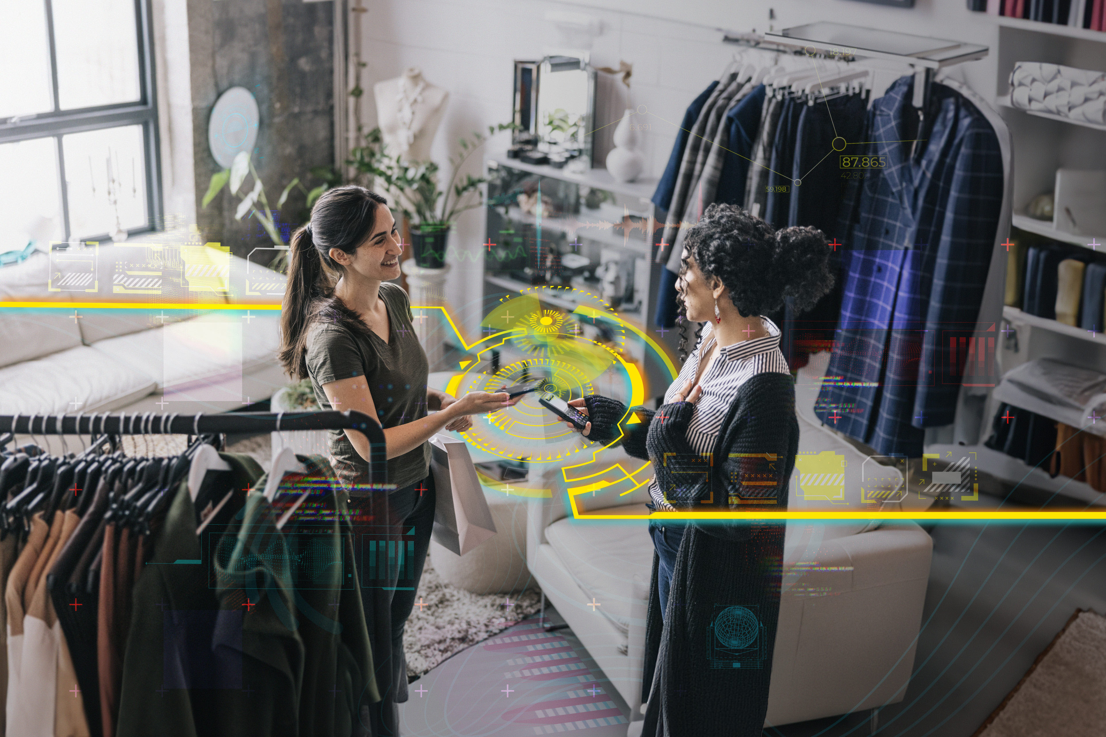 Latin woman making a mobile payment in modern boutique