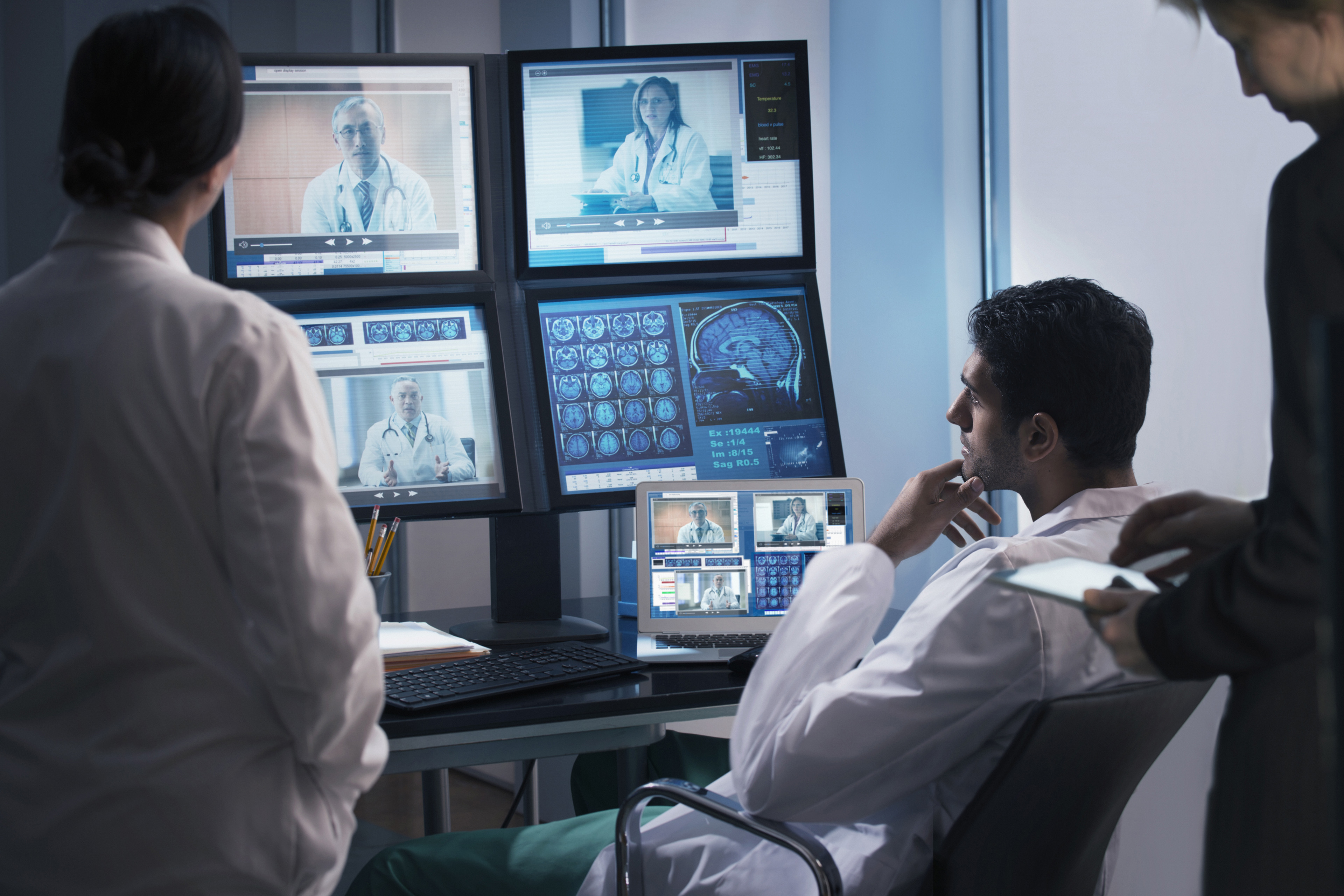 Doctors examining x rays in video conference