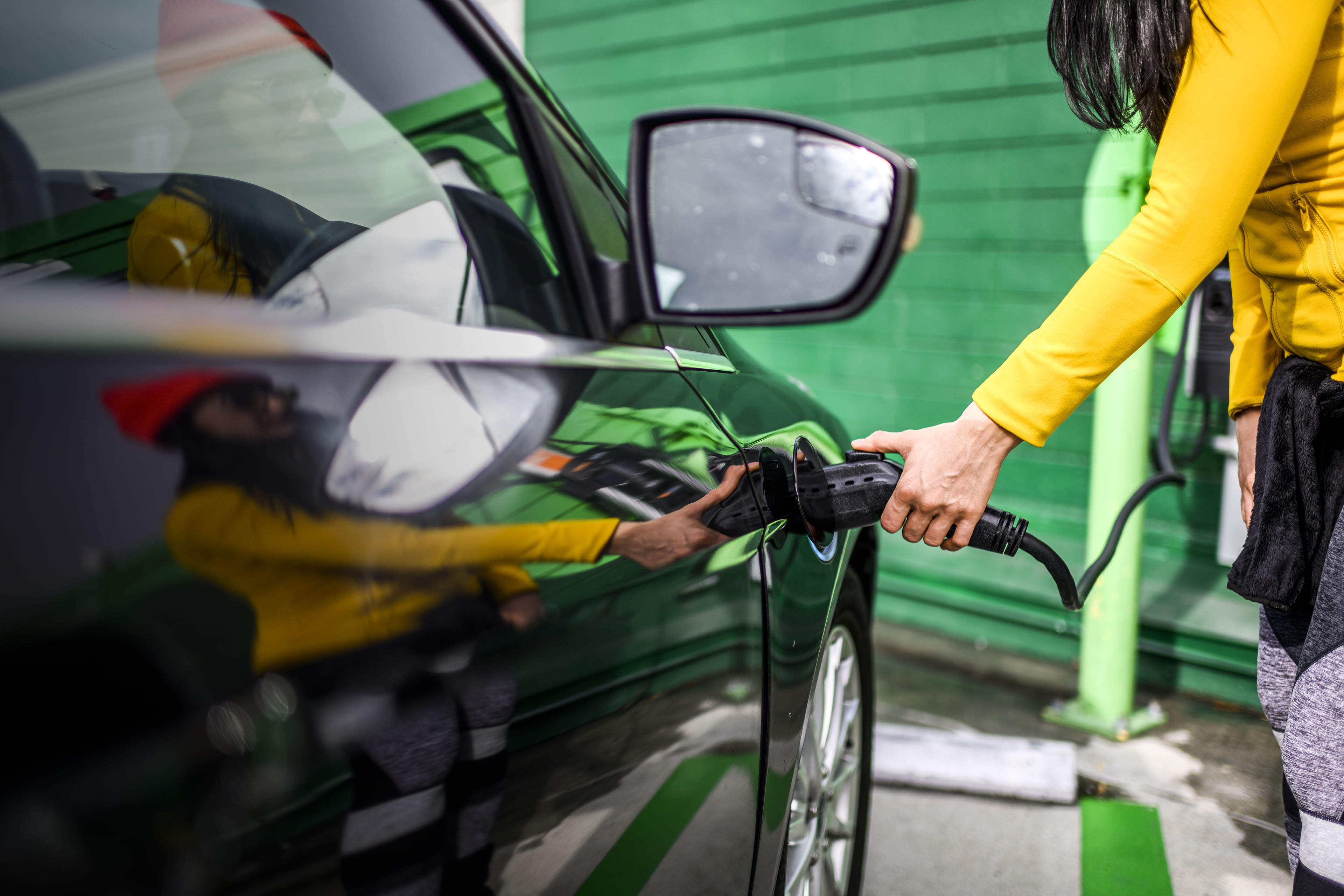 Plugging a charging connector into an electric vehicle