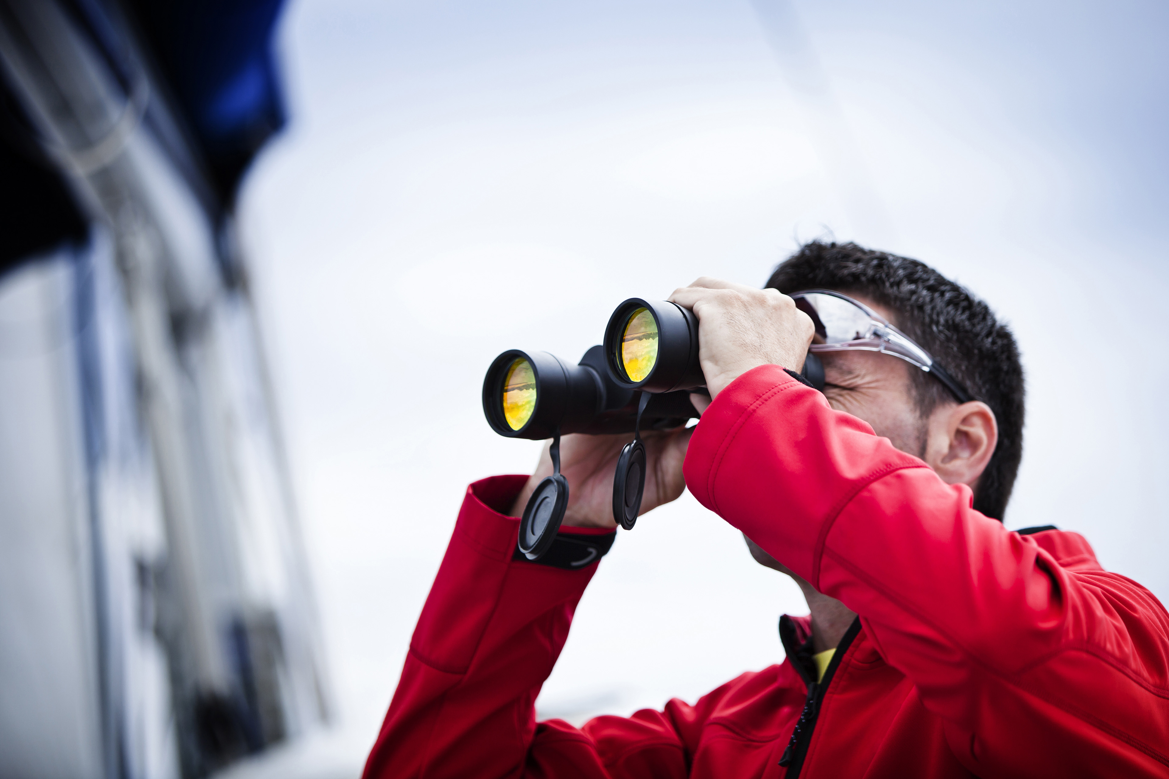 Sailor with binoculars in red jacket