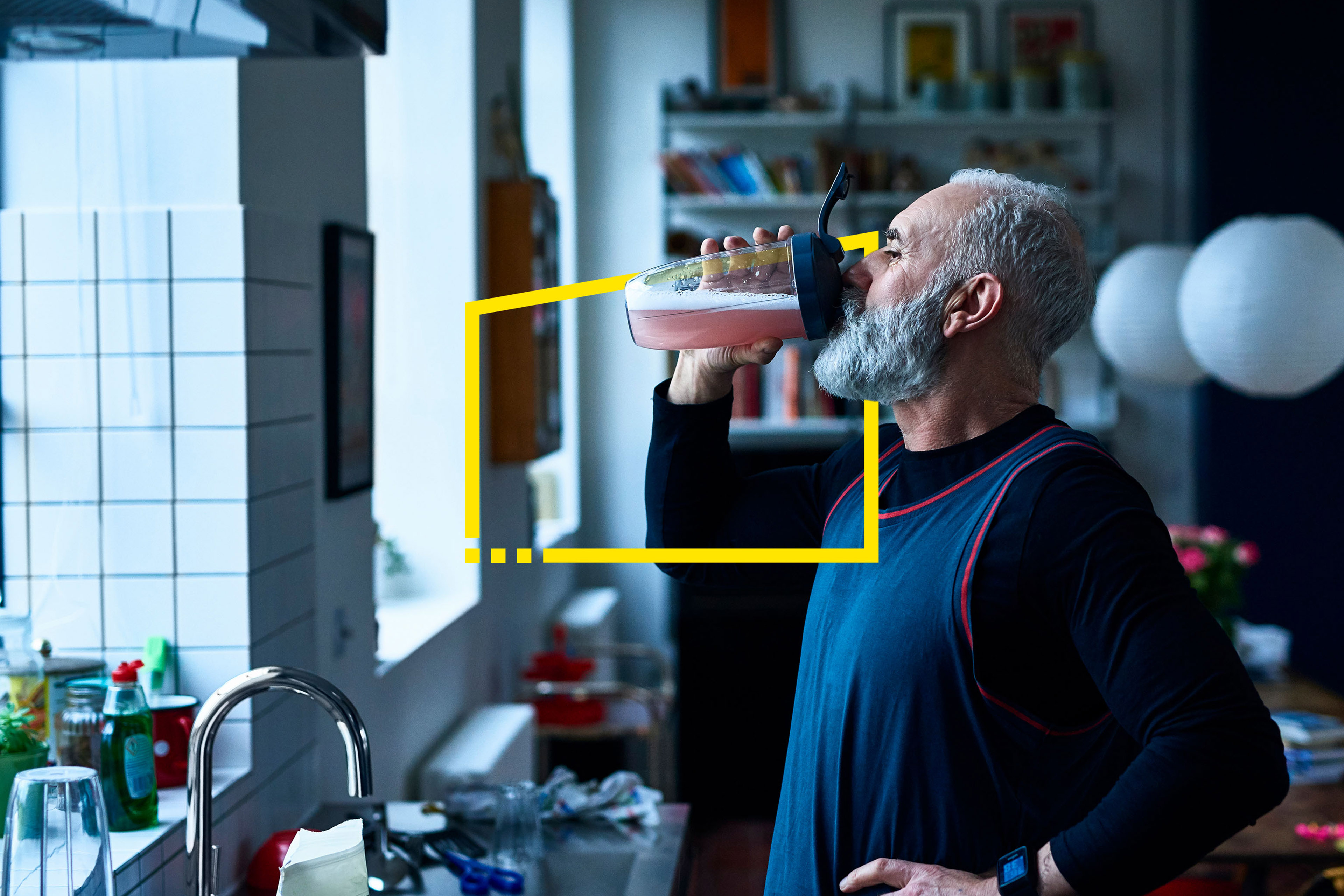 Man drinking sports drink kitchen sink