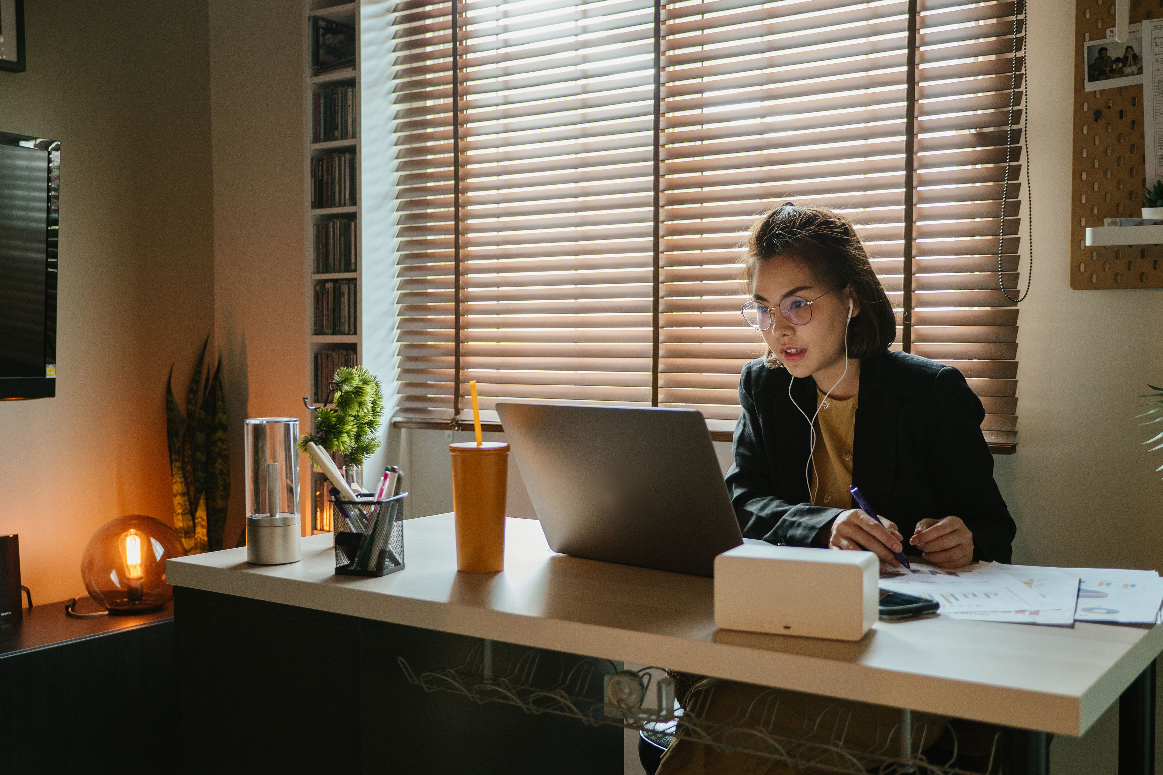  Business women using laptop on video call at home office