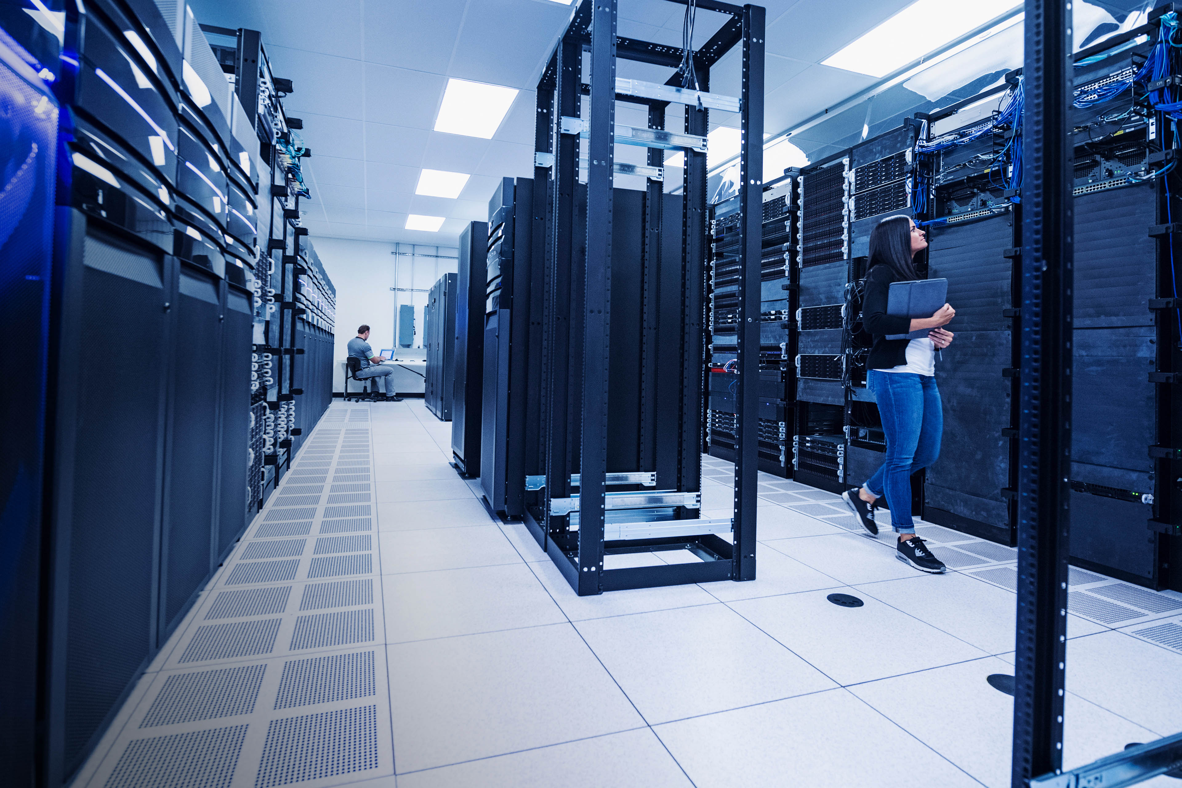 Woman and man working in server room