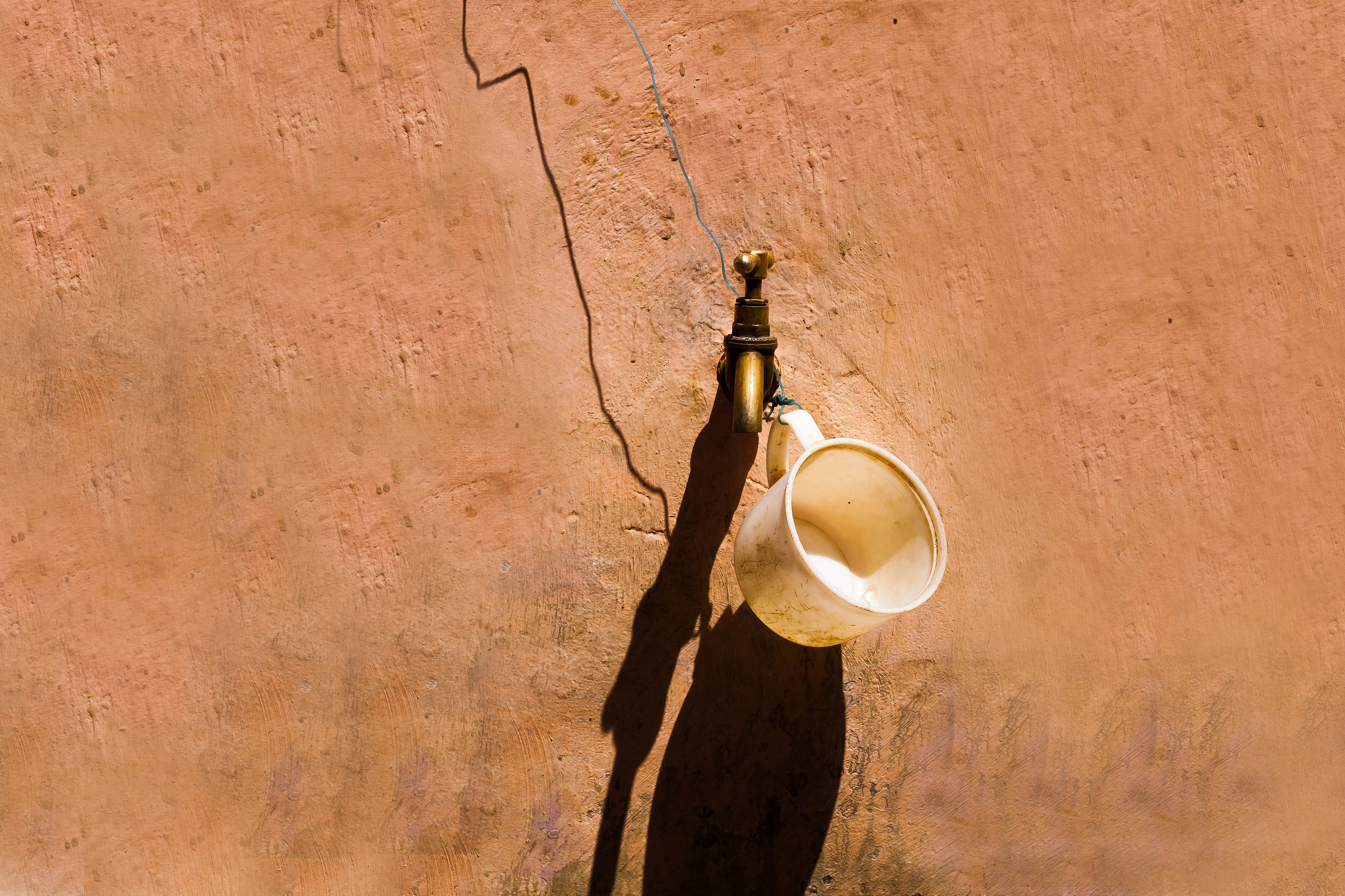 Cup hangs tap outside