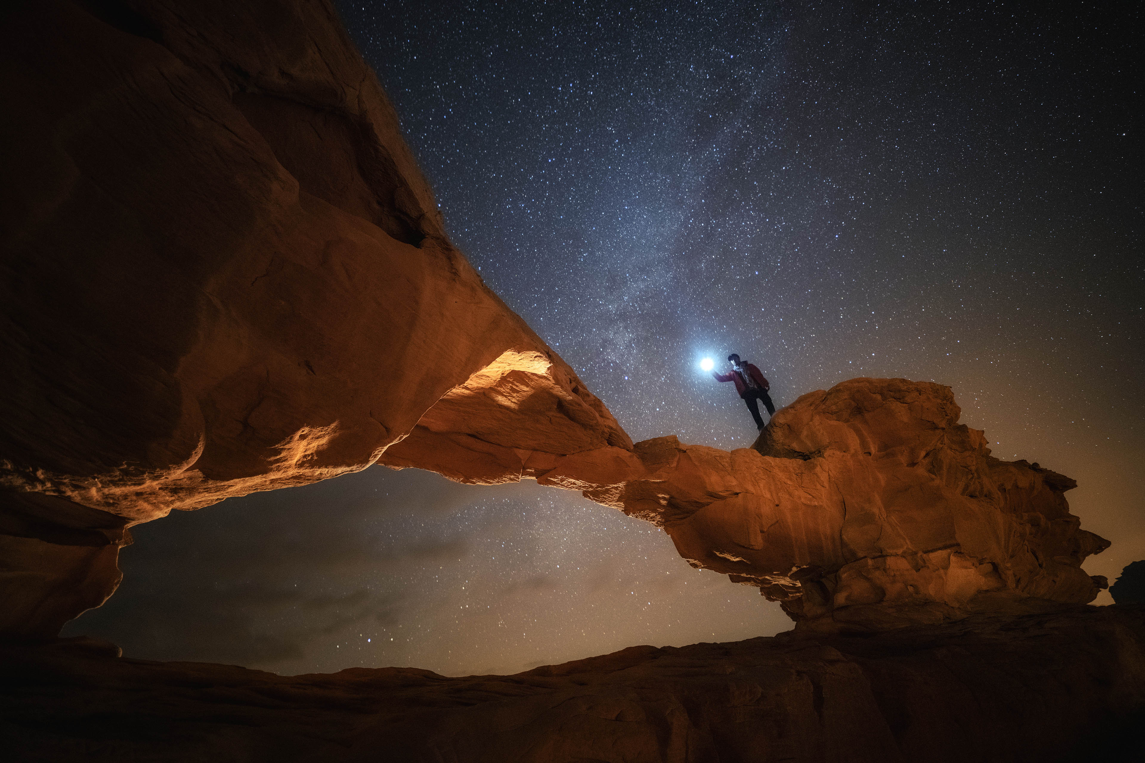 Night and star scene of stone arc in wadi rum jordan