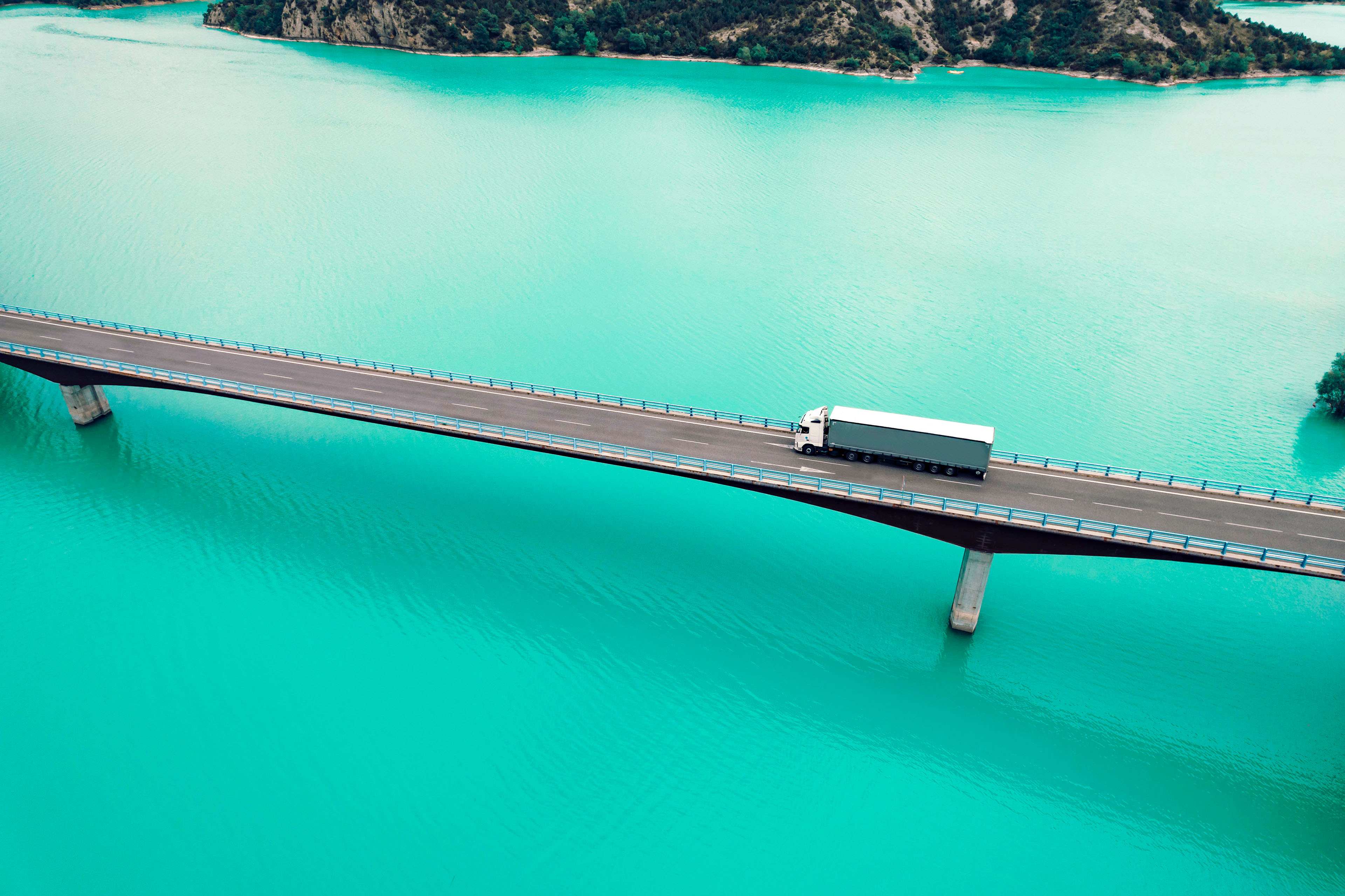 Bridge crossing blue lake in the pyrenees mountains Spain