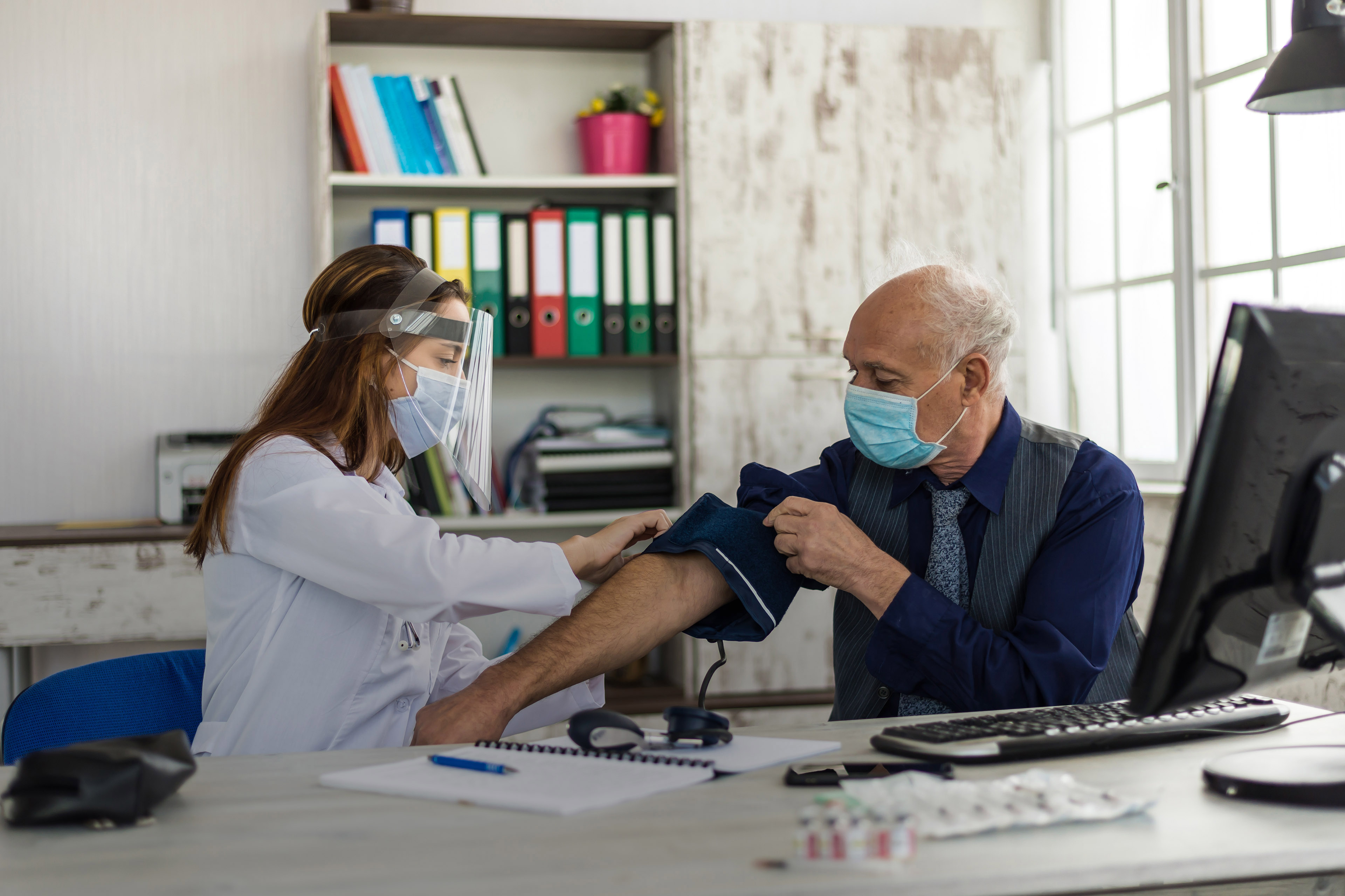 Man taking vaccine from his doctor