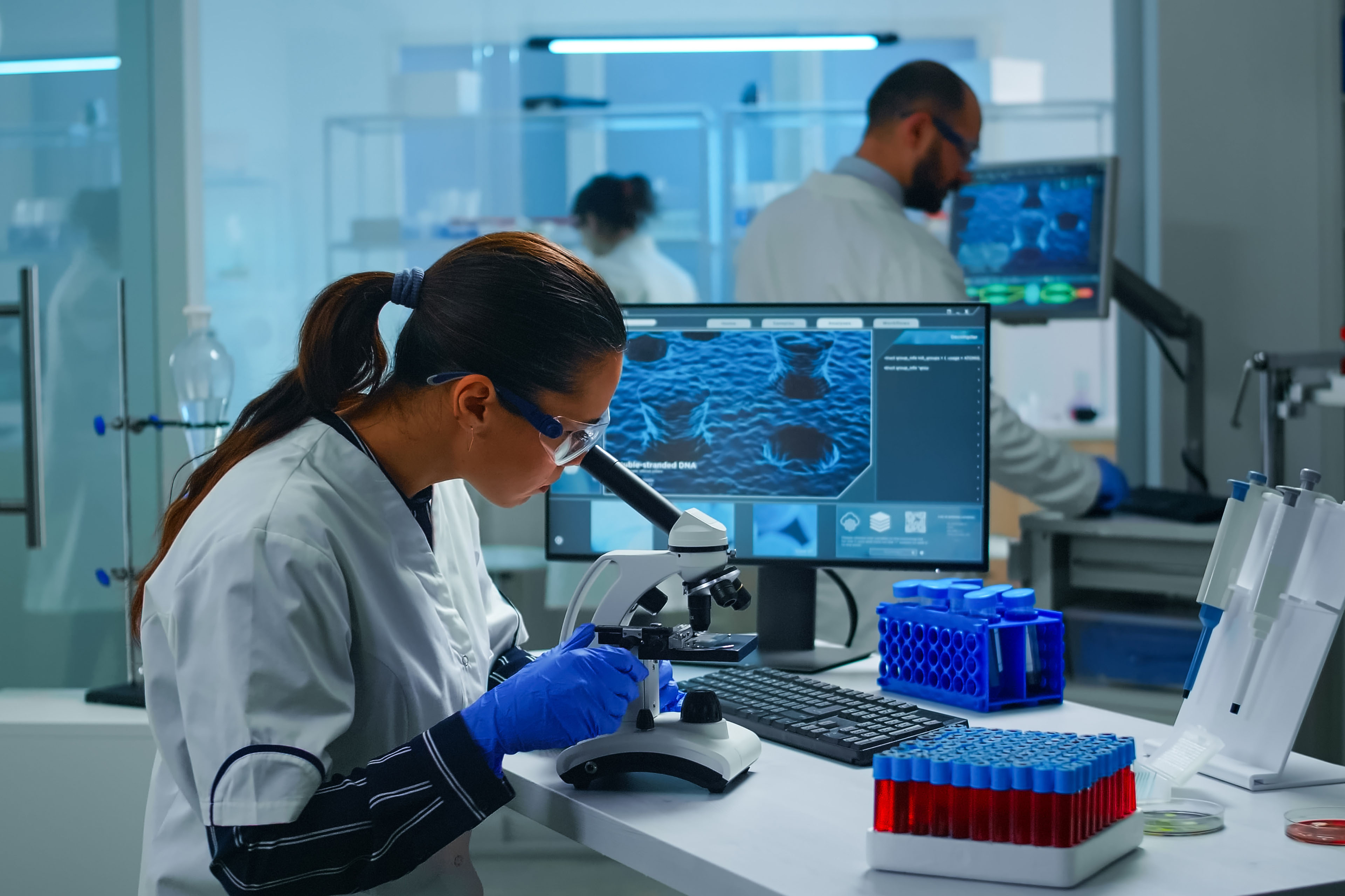 Medical research scientist conducting experiments under microscope