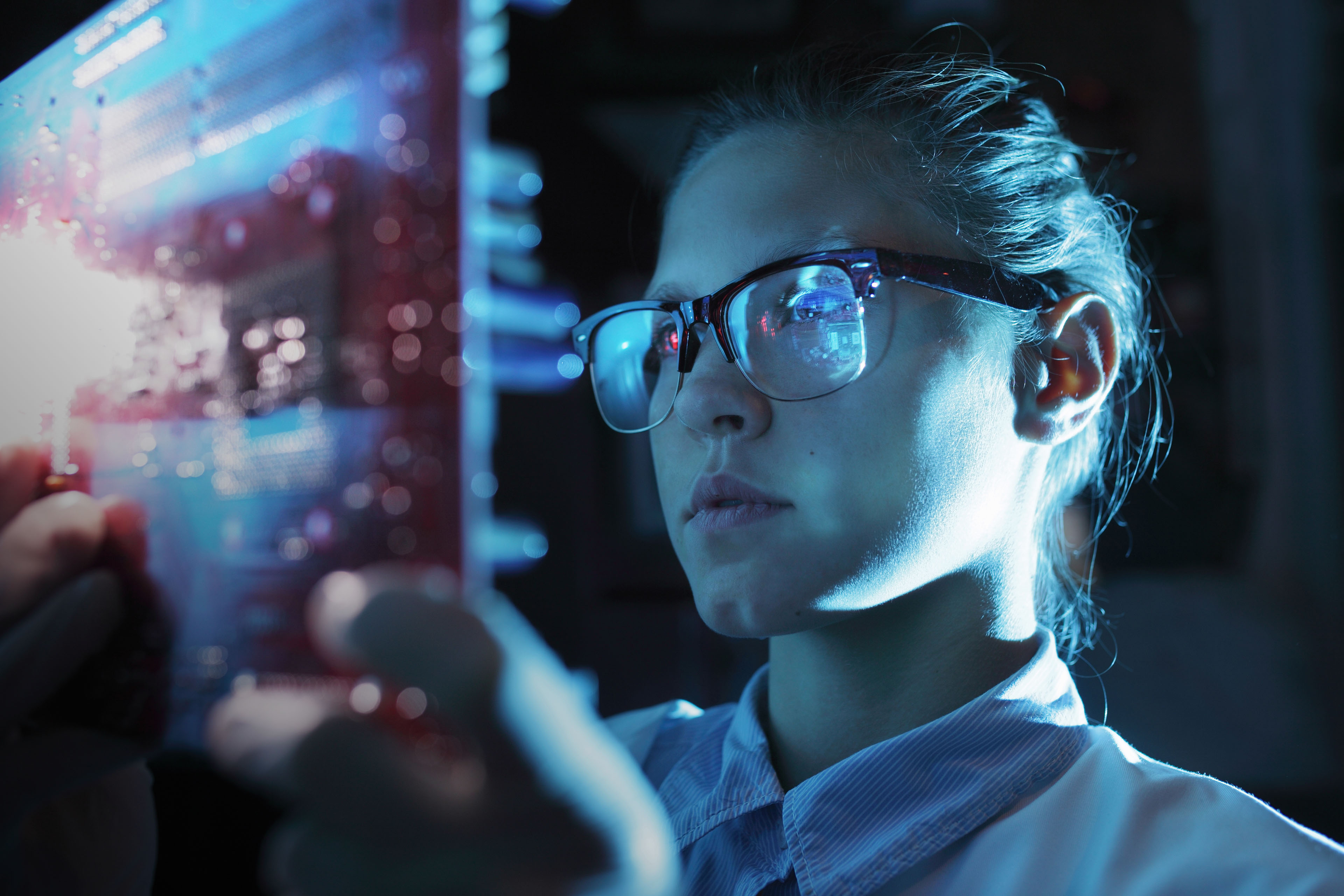 Woman looking at integrated circuit