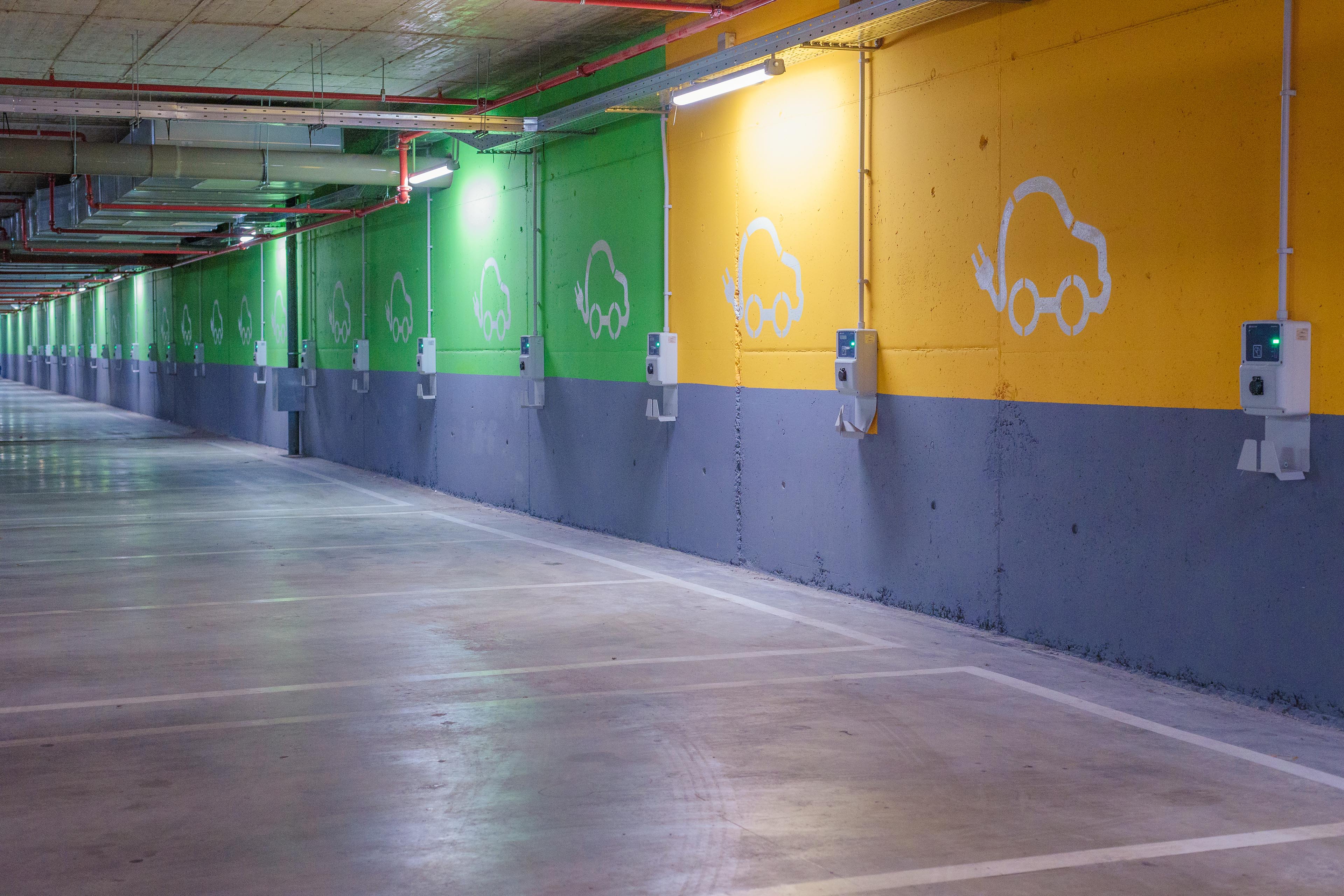 Electric vehicle logo on the wall of a parking space