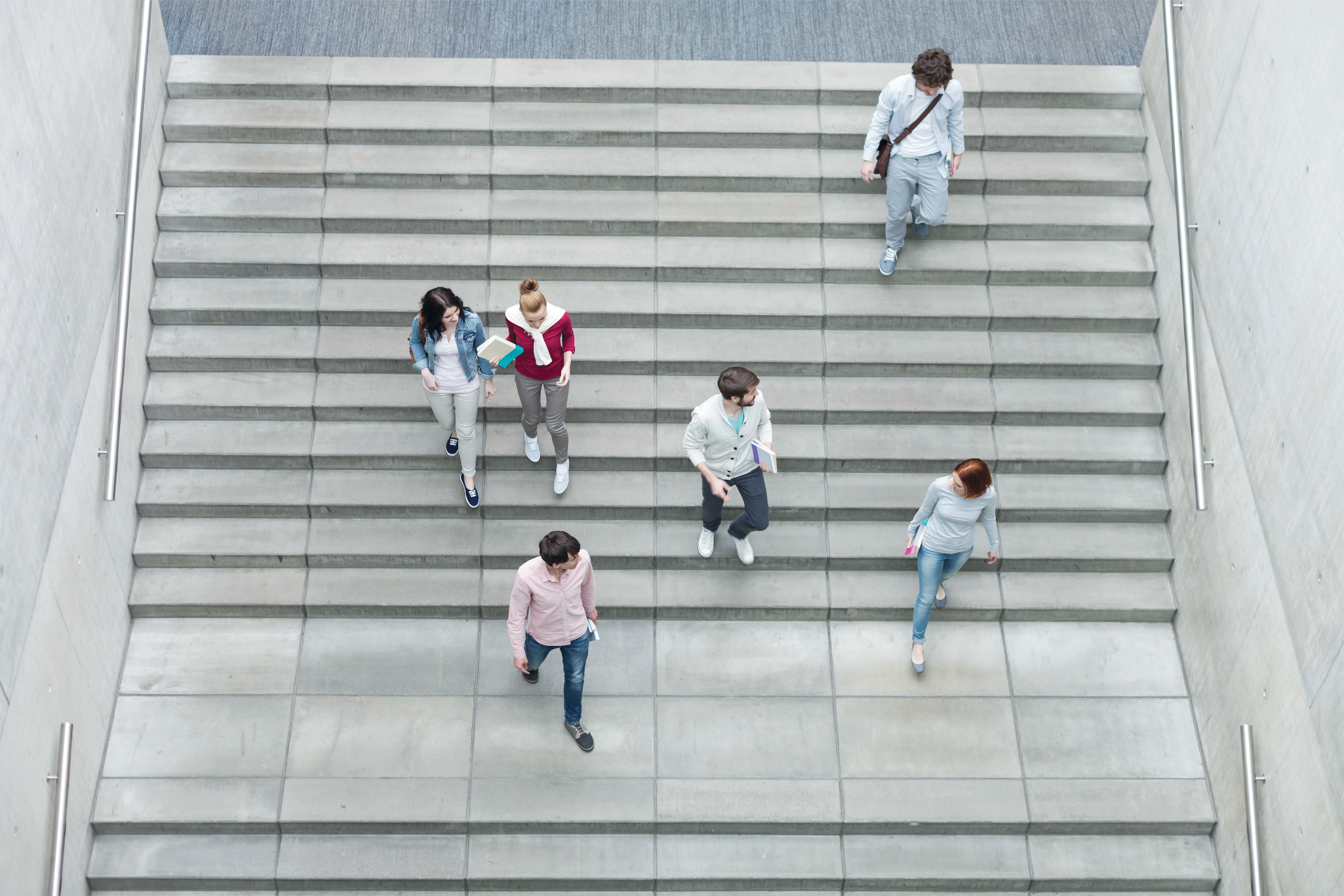 Young adults walking down stairs