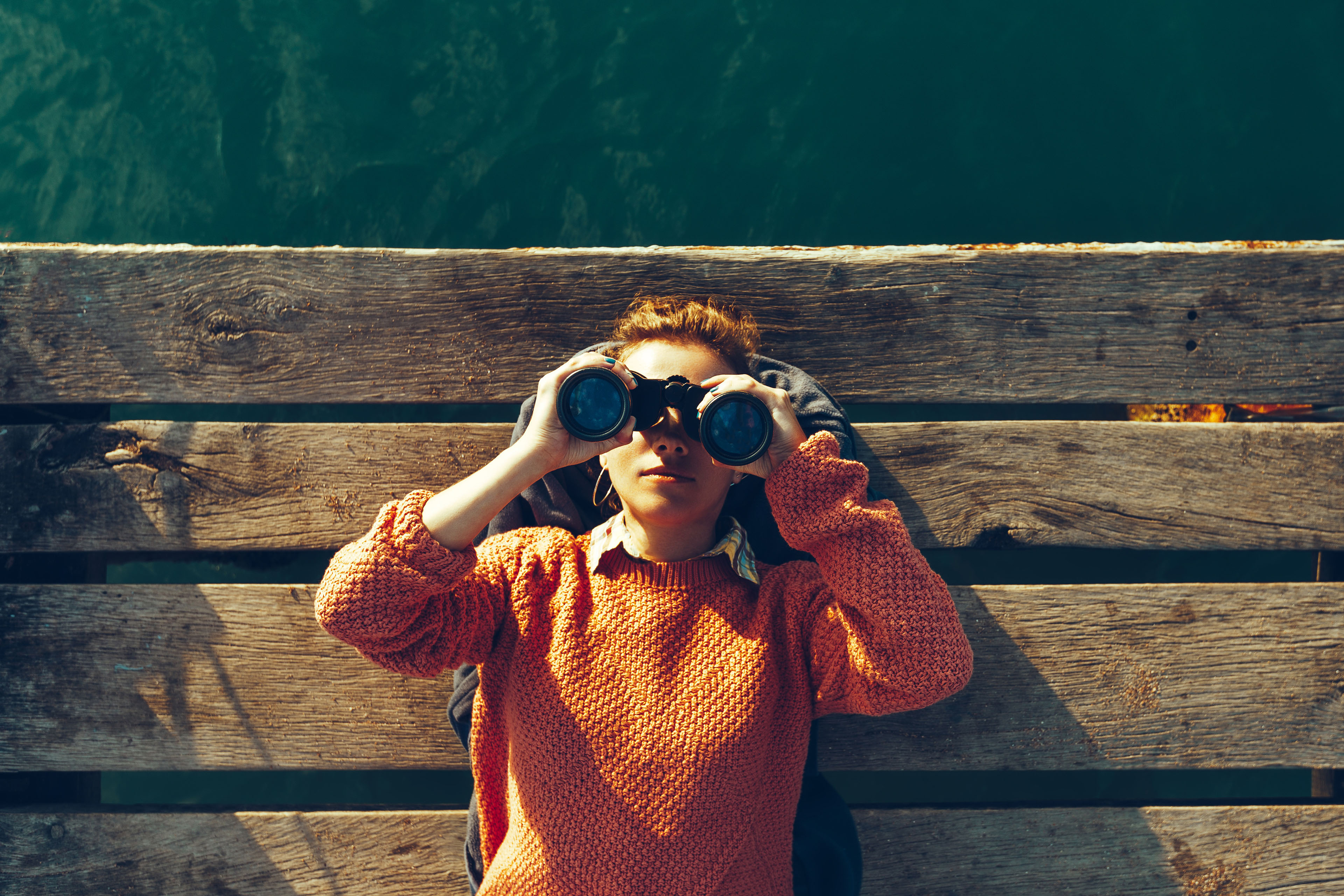  Young girl on pier looking through binoculars