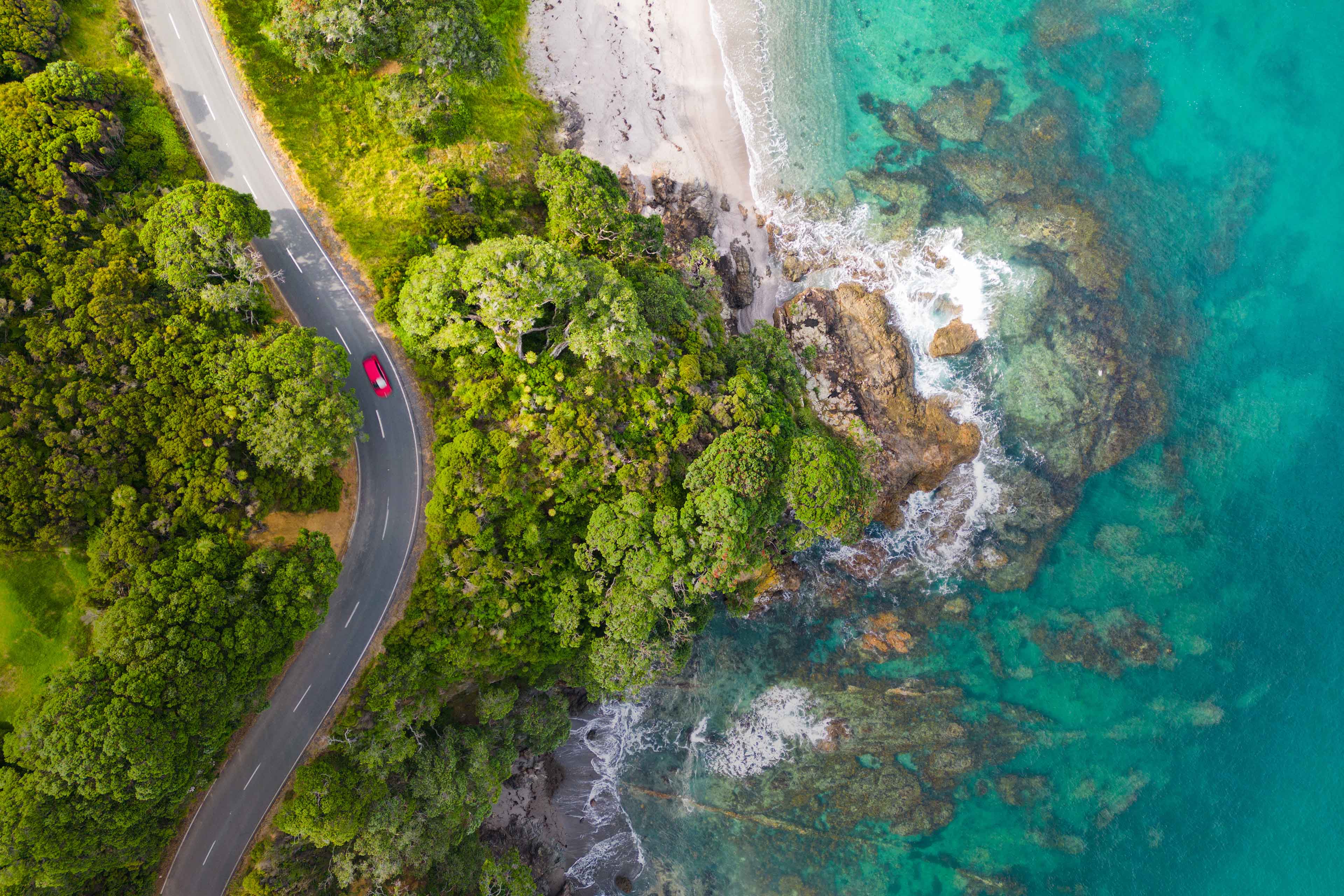 Aerial view of seaside road approaching a beach