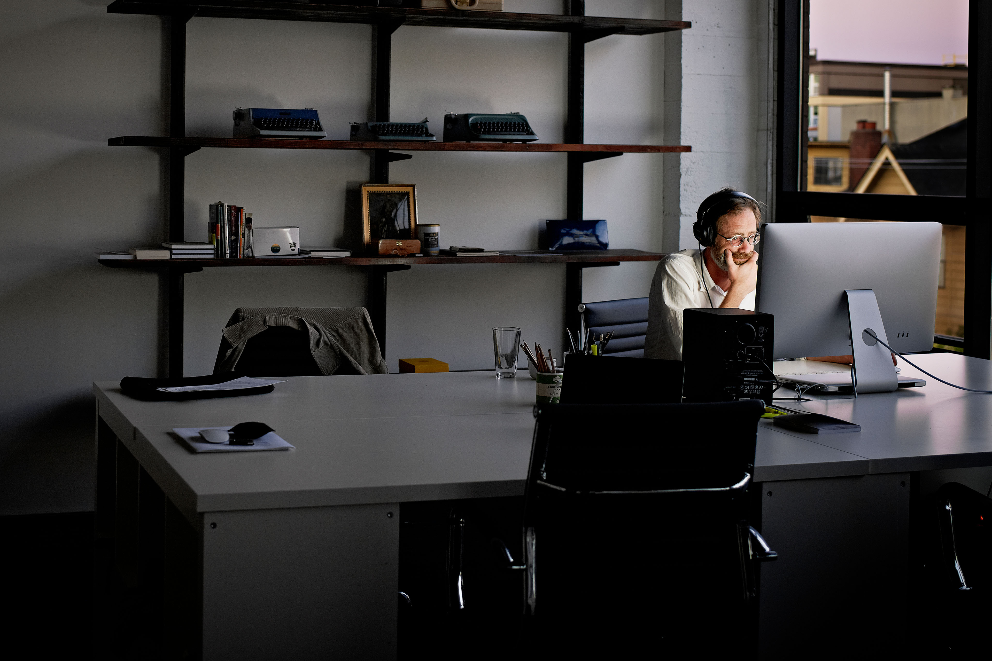 Businessman sitting working on computer at night