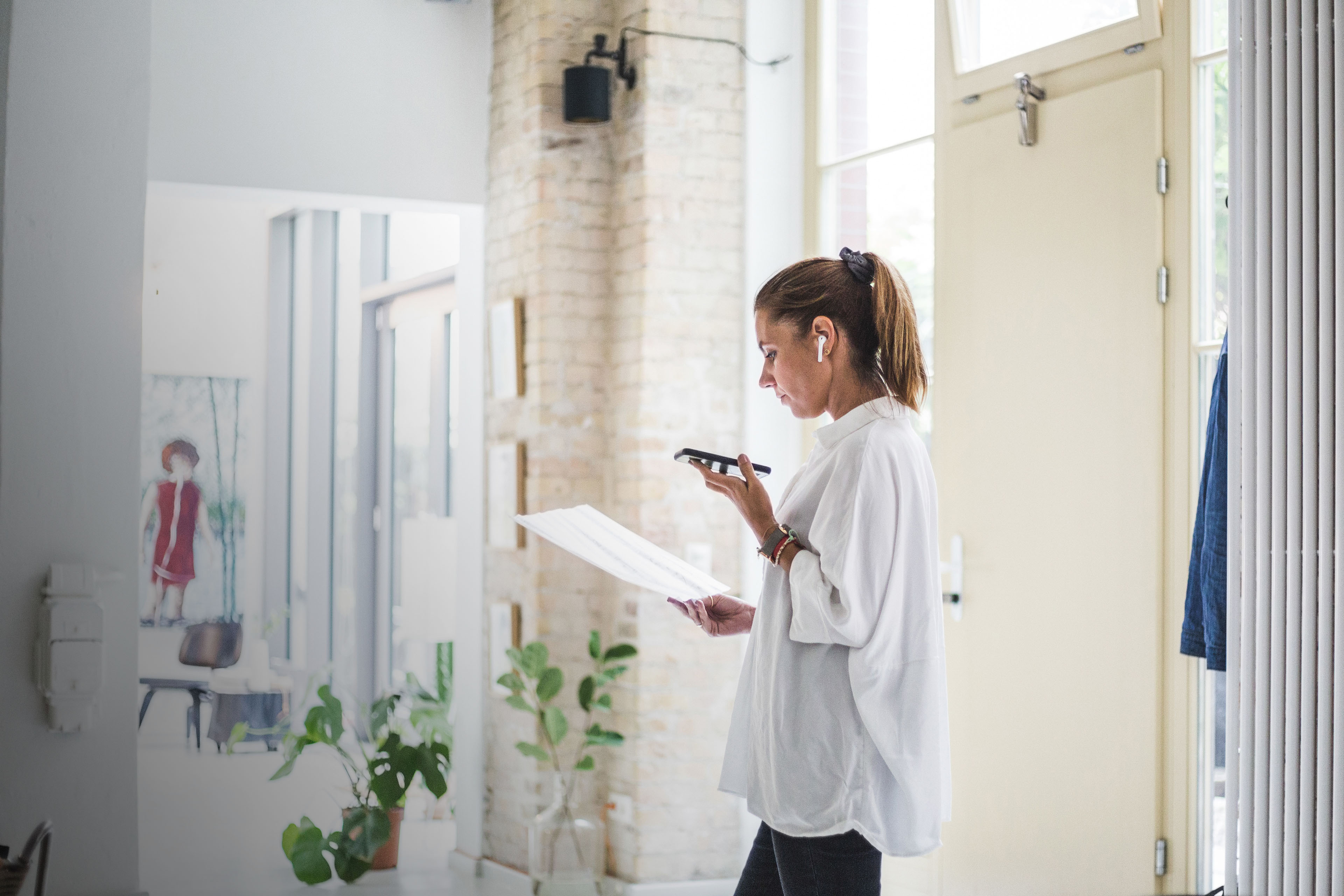 Businesswoman reviews figures while talking on phone