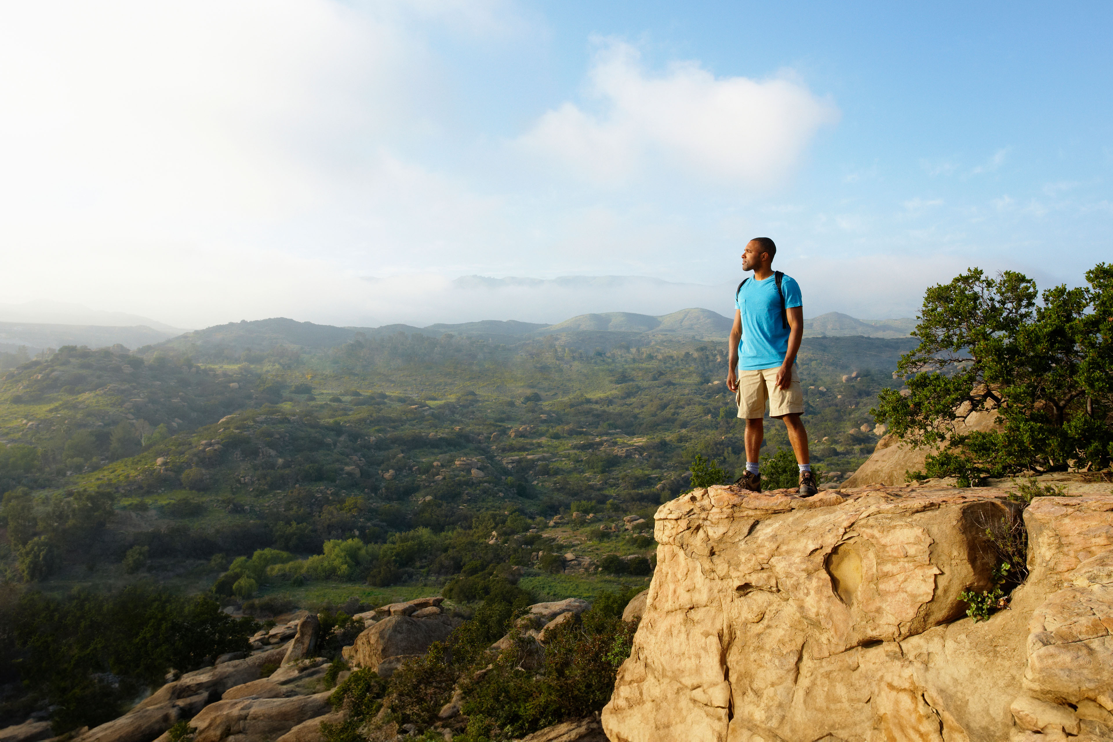 Man hiking and looking out of valley