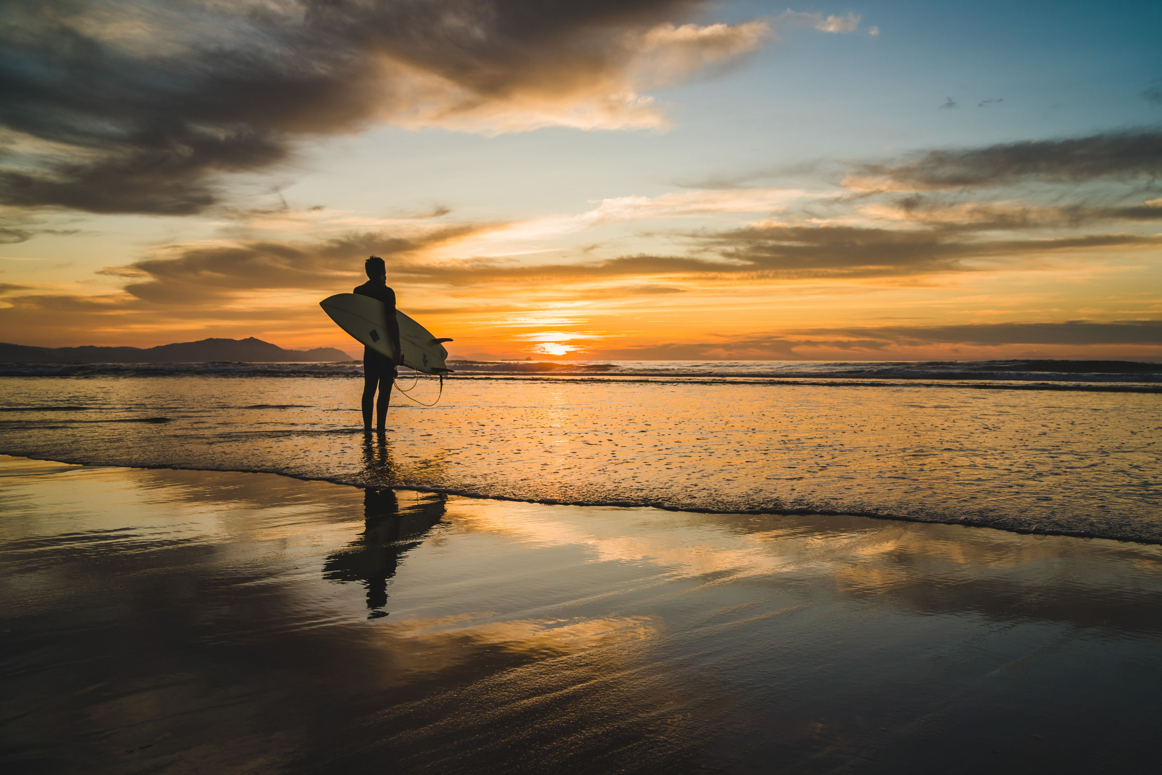 Silhouette of a surfer standing-on-the-beach-of-the-atlantic-ocean