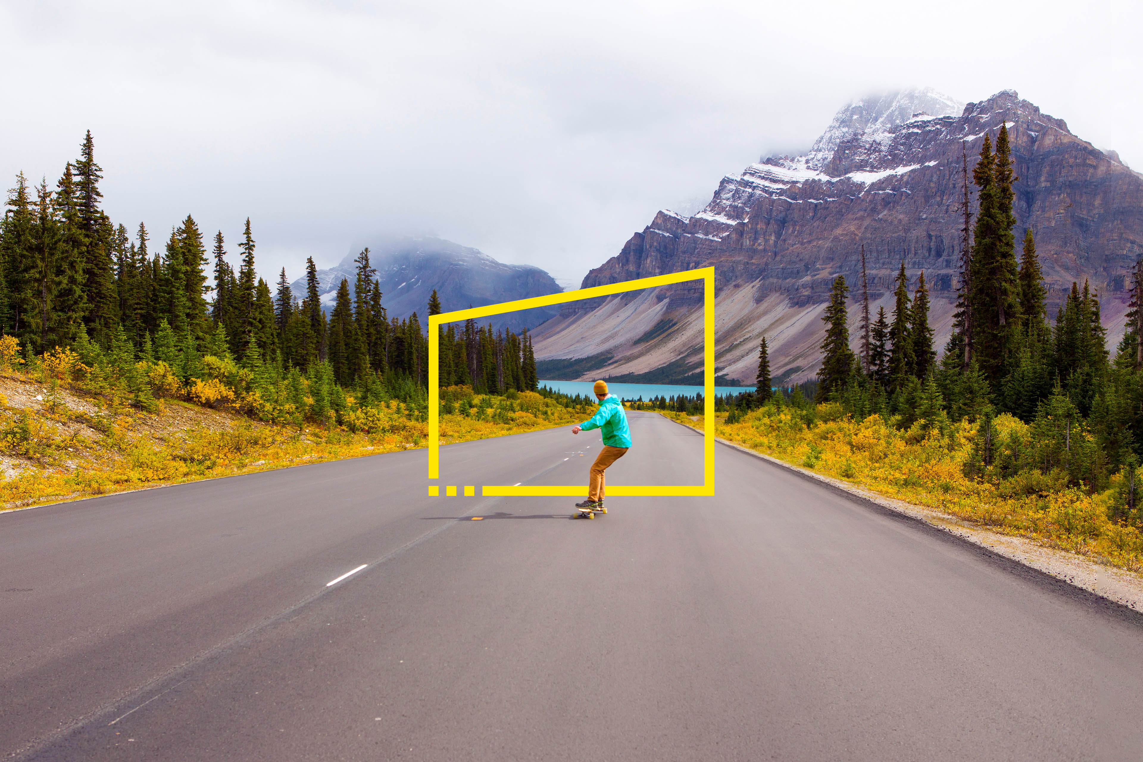 A man longboarding down a scenic road