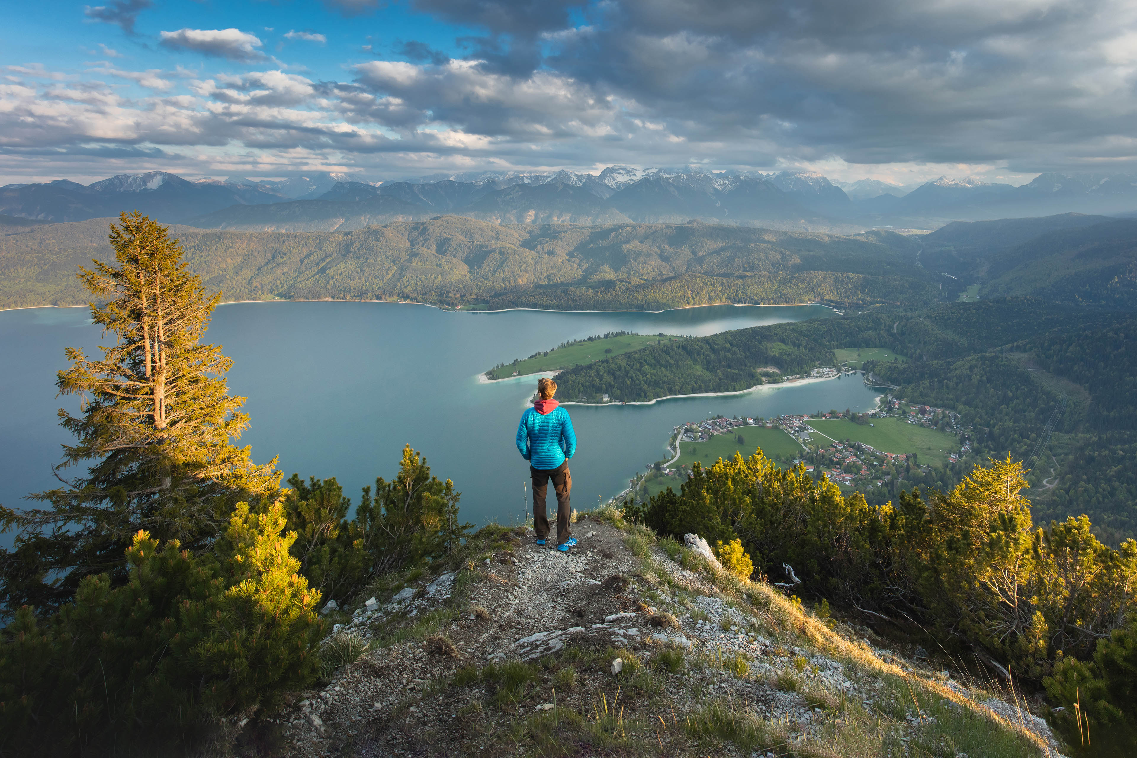 Man looking over a lake in the bavarian mountains