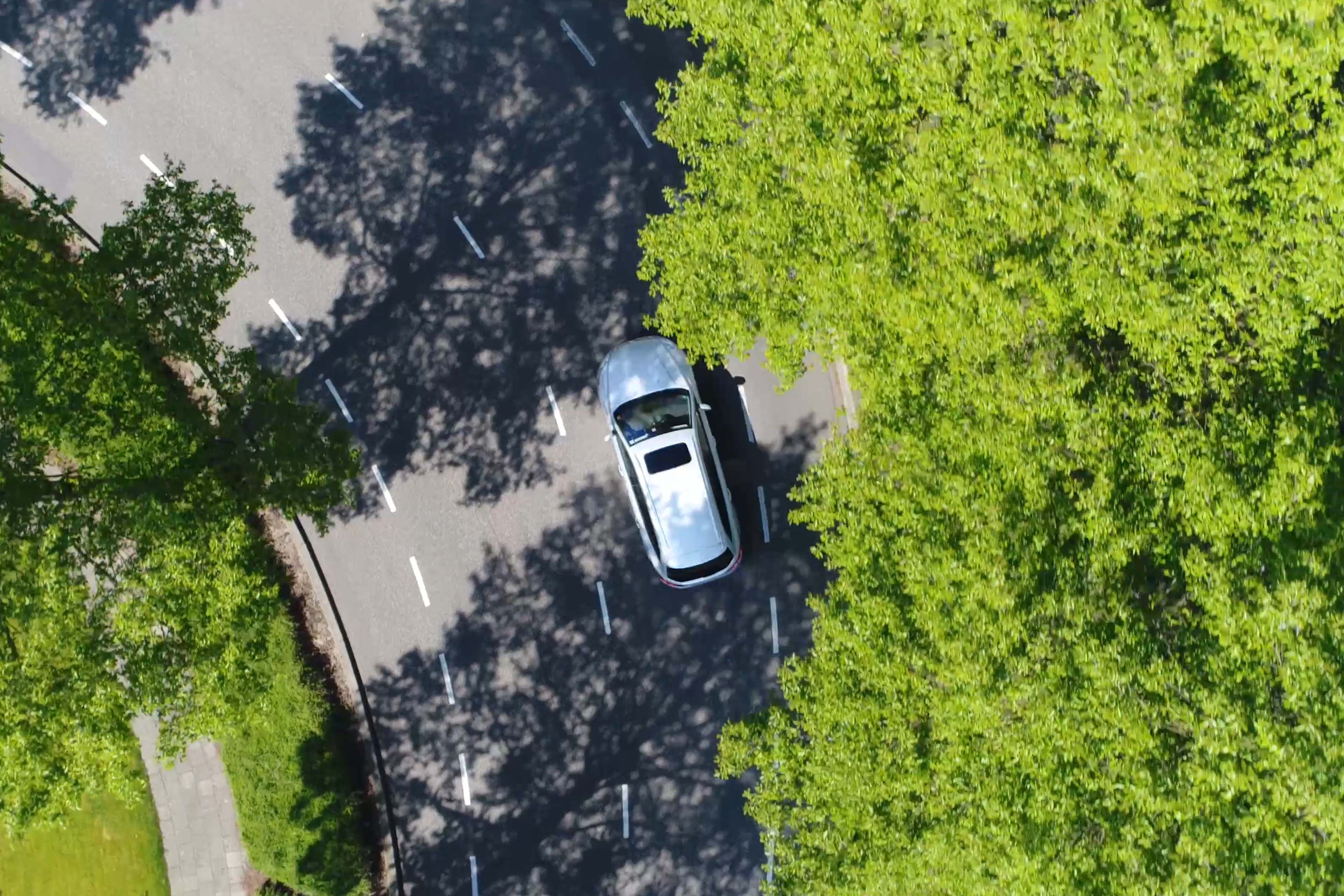 Aerial view of wagon driving over two way street corner