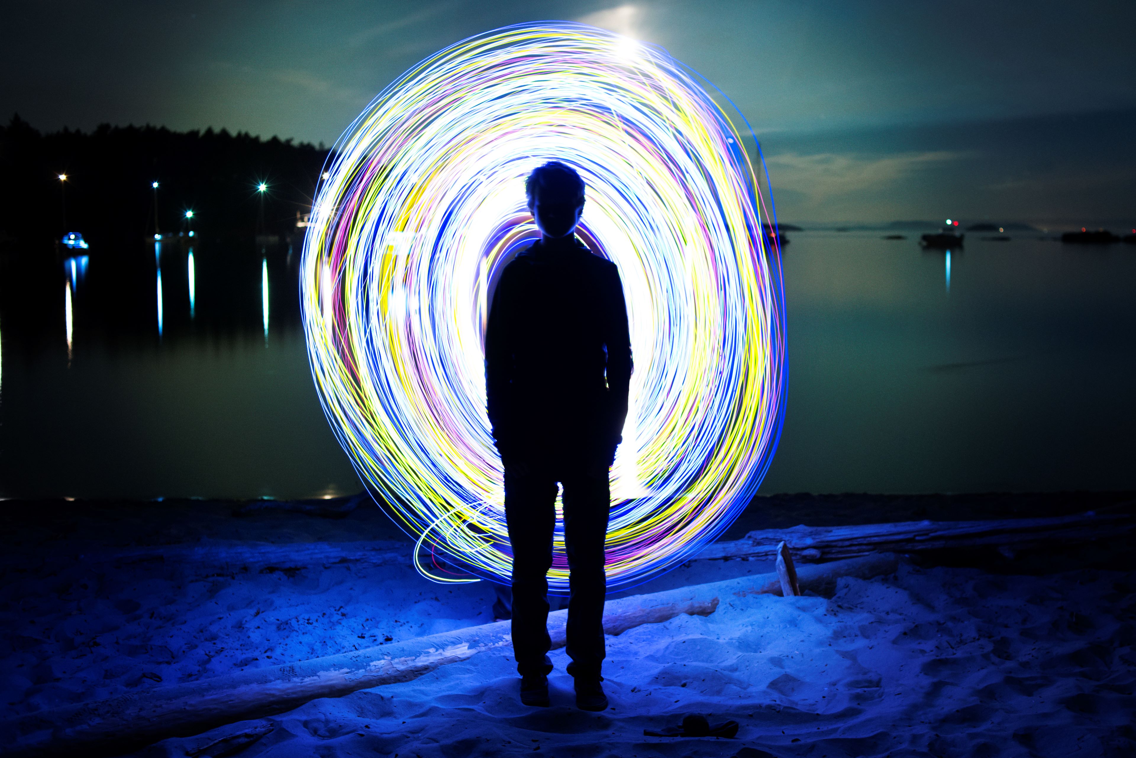 Silhouette man standing against illuminated wire wool at sucia island