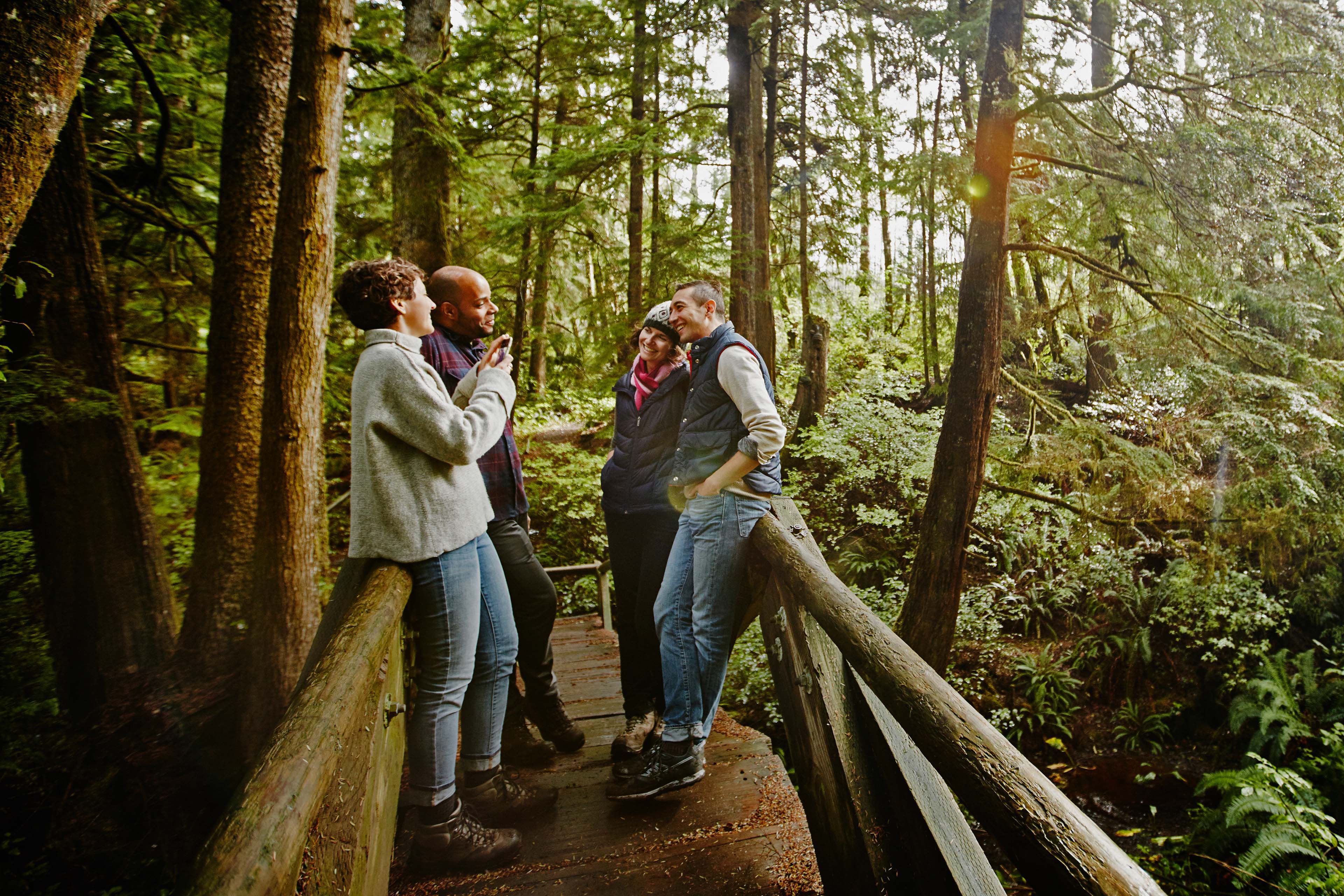 Woman taking photo of friends with smartphone