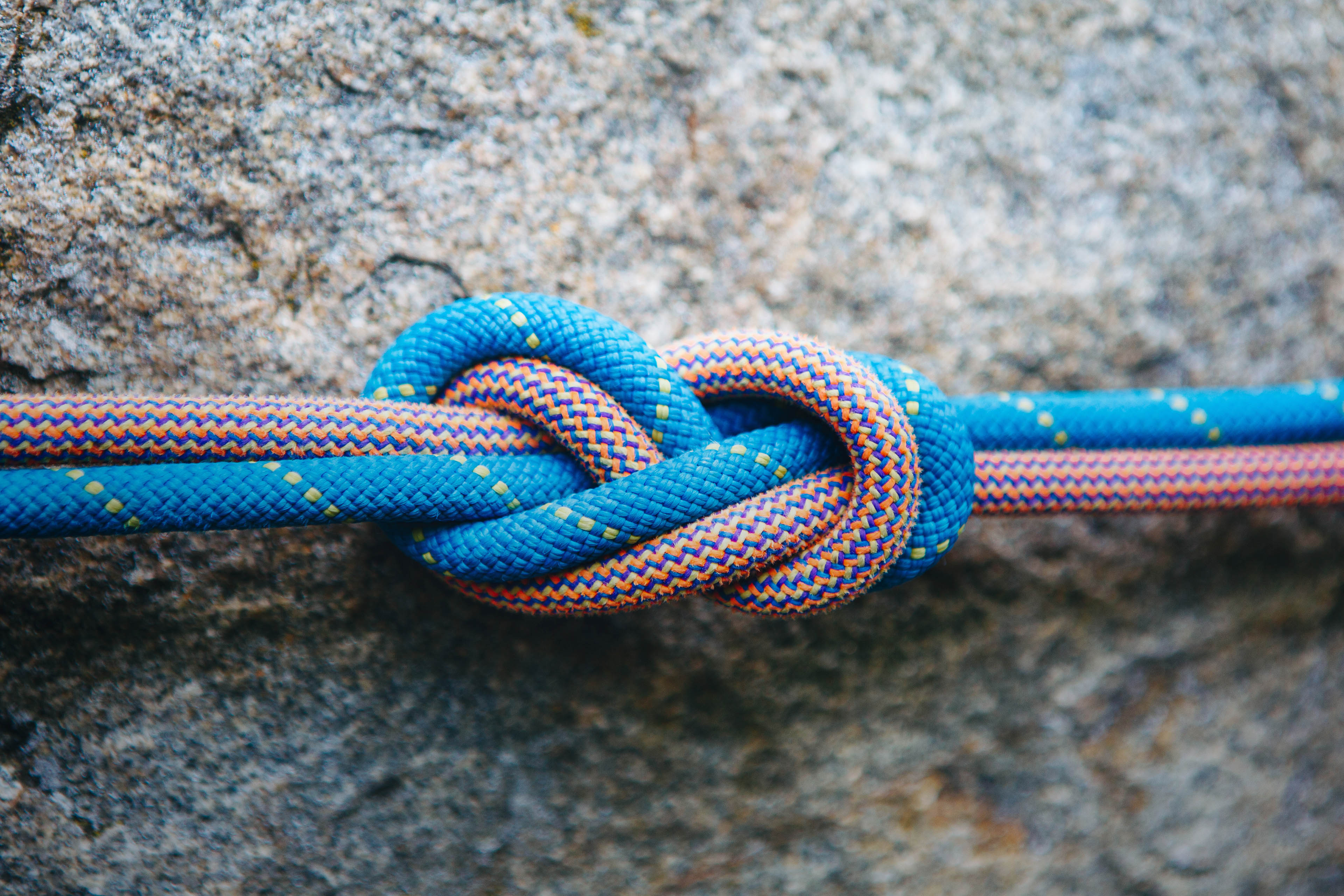 Eight rope knot on rocky background