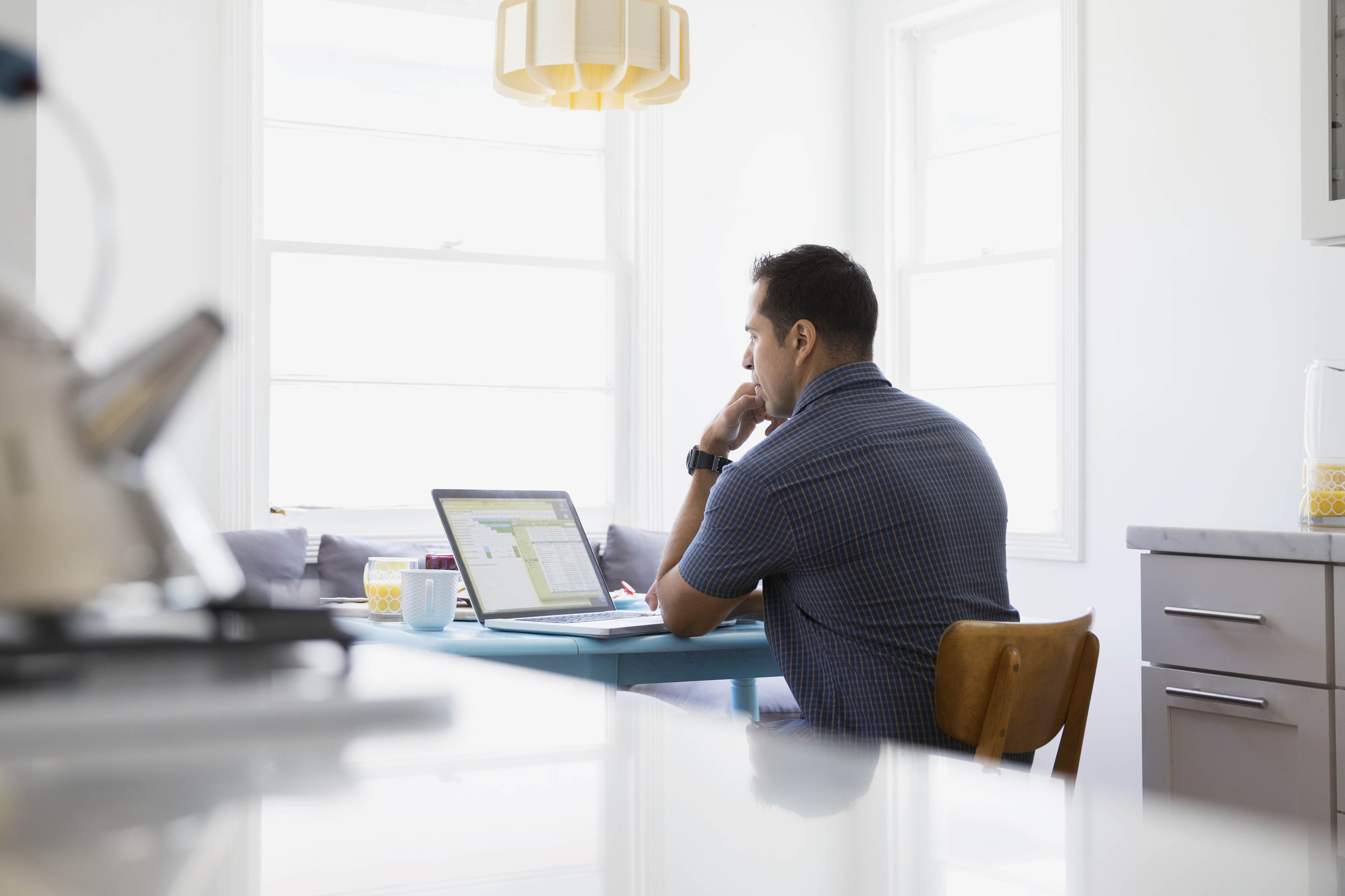 Serious Brunette man using laptop