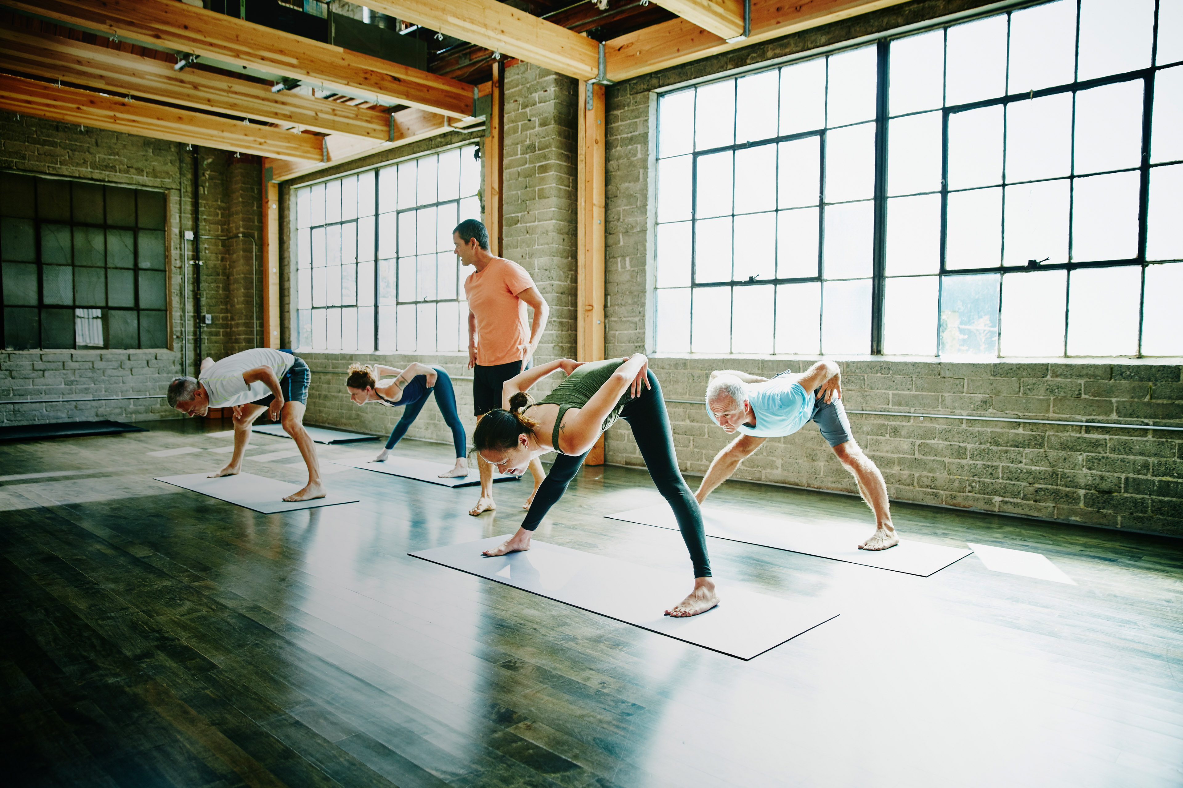 Yoga instructor watching students in pose