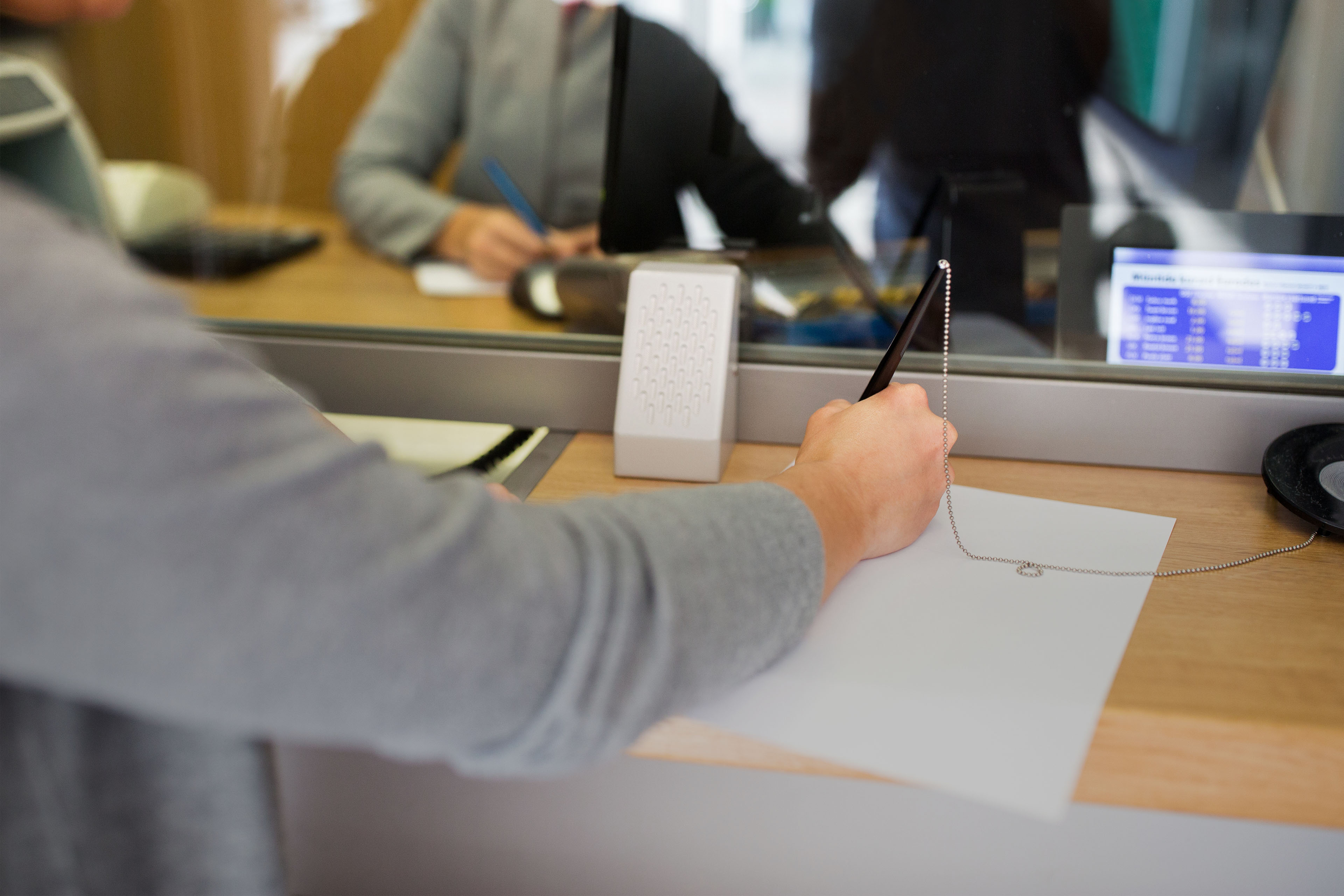 A customer writing application at bank office