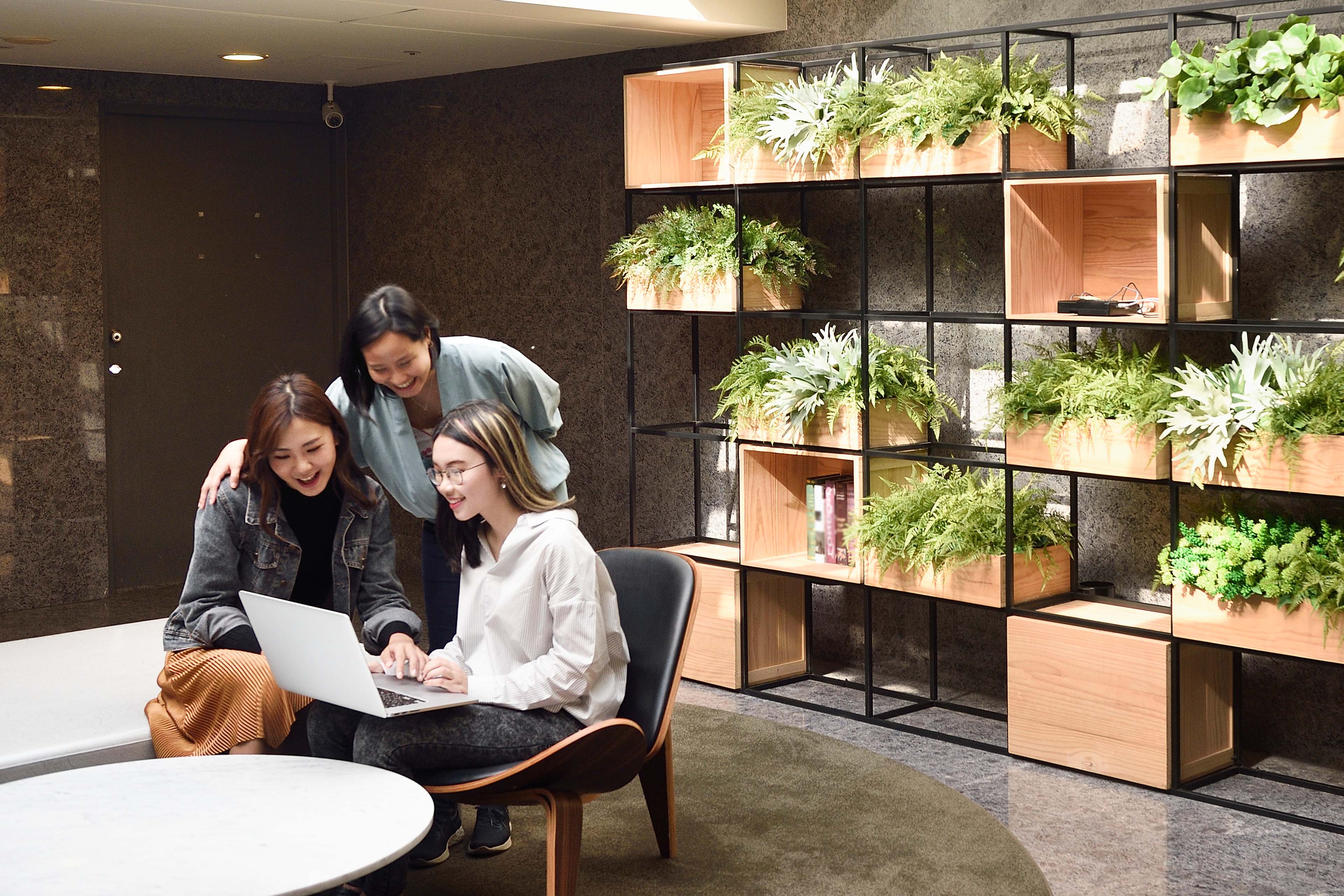 Three women working together in a modern office