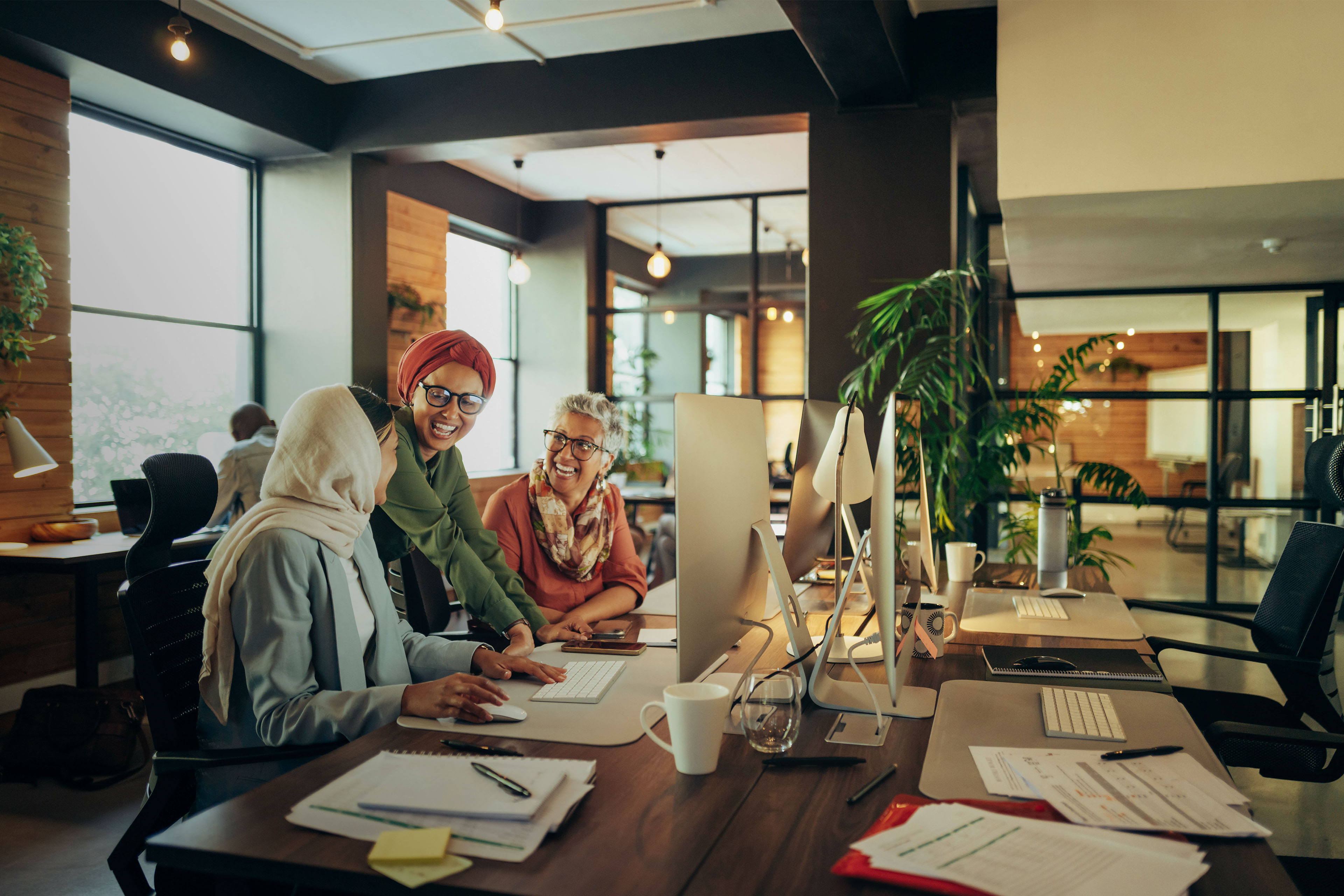 Happy businesswomen working as a team in a coworking space