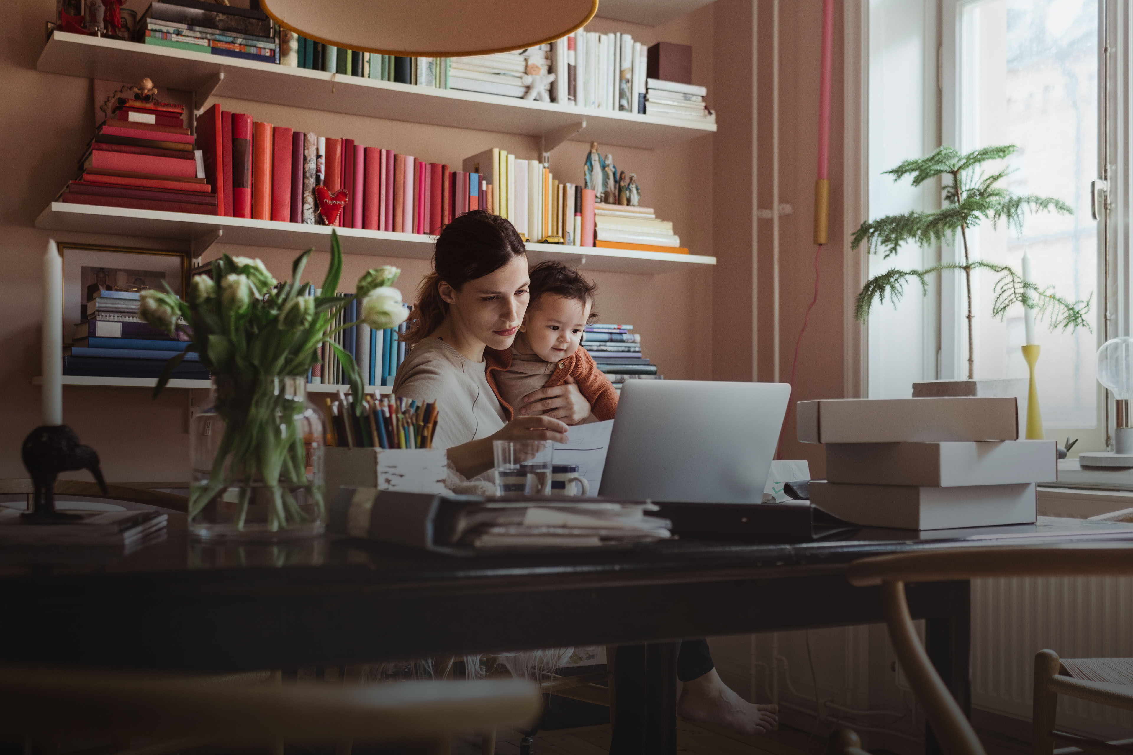 Women using laptop at home with her child